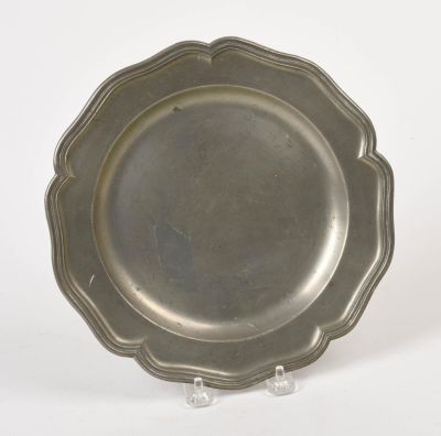 19th C. Pewter Plate. With scalloped rim, marked with a winged angel, diameter 9.5 inches.