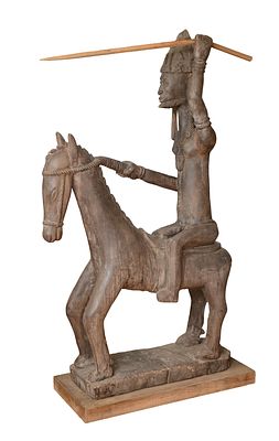 African Dogon Warrior Sculpture. Height 77 inches, length 44.75 inches, width 18 inches. Spear