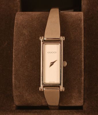 Gucci Stainless Steel Lady's Watch. Face 1 x .5 inches, wrist diameter 2.125 inches. Needs new 