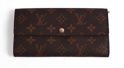Louis Vuitton Leather Wallet. 4 x 7.5 inches. Some wear to interior. Guaranteed authentic. With 
