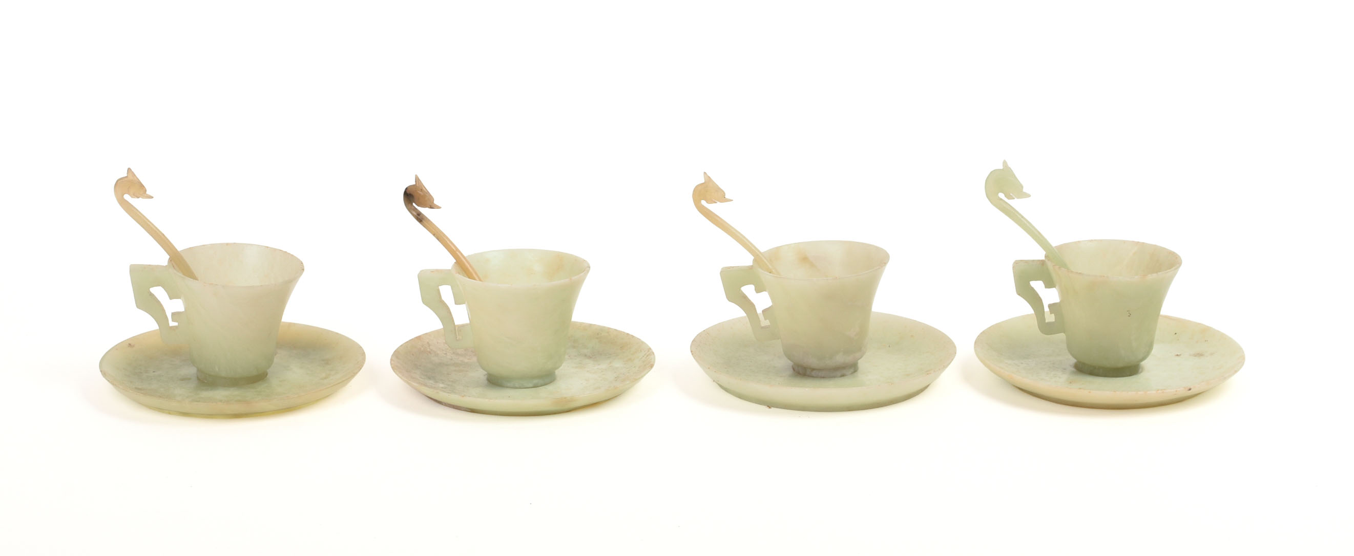 FOUR CHINESE JADE TEA CUPS, SAUCERS, AND SPOONS.
