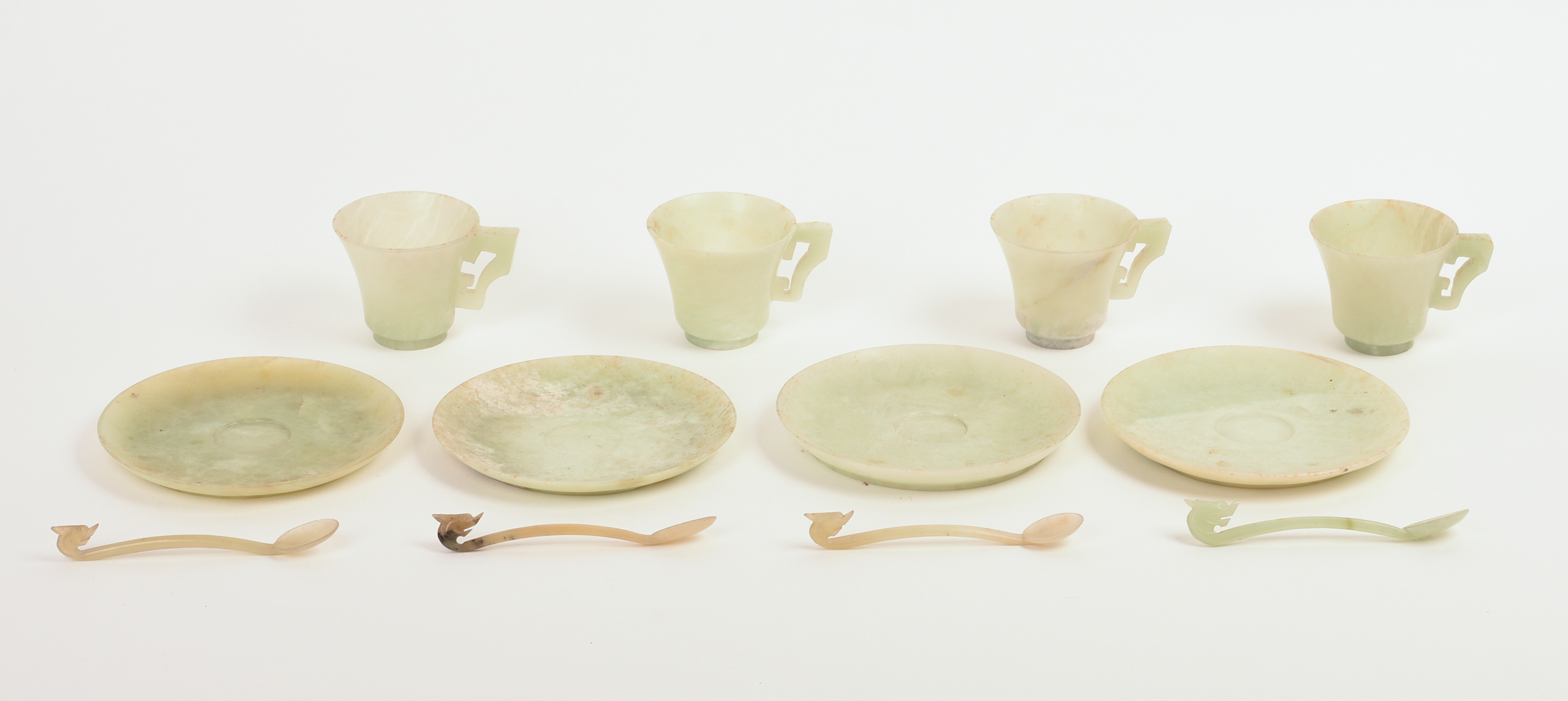 FOUR CHINESE JADE TEA CUPS, SAUCERS, AND SPOONS.