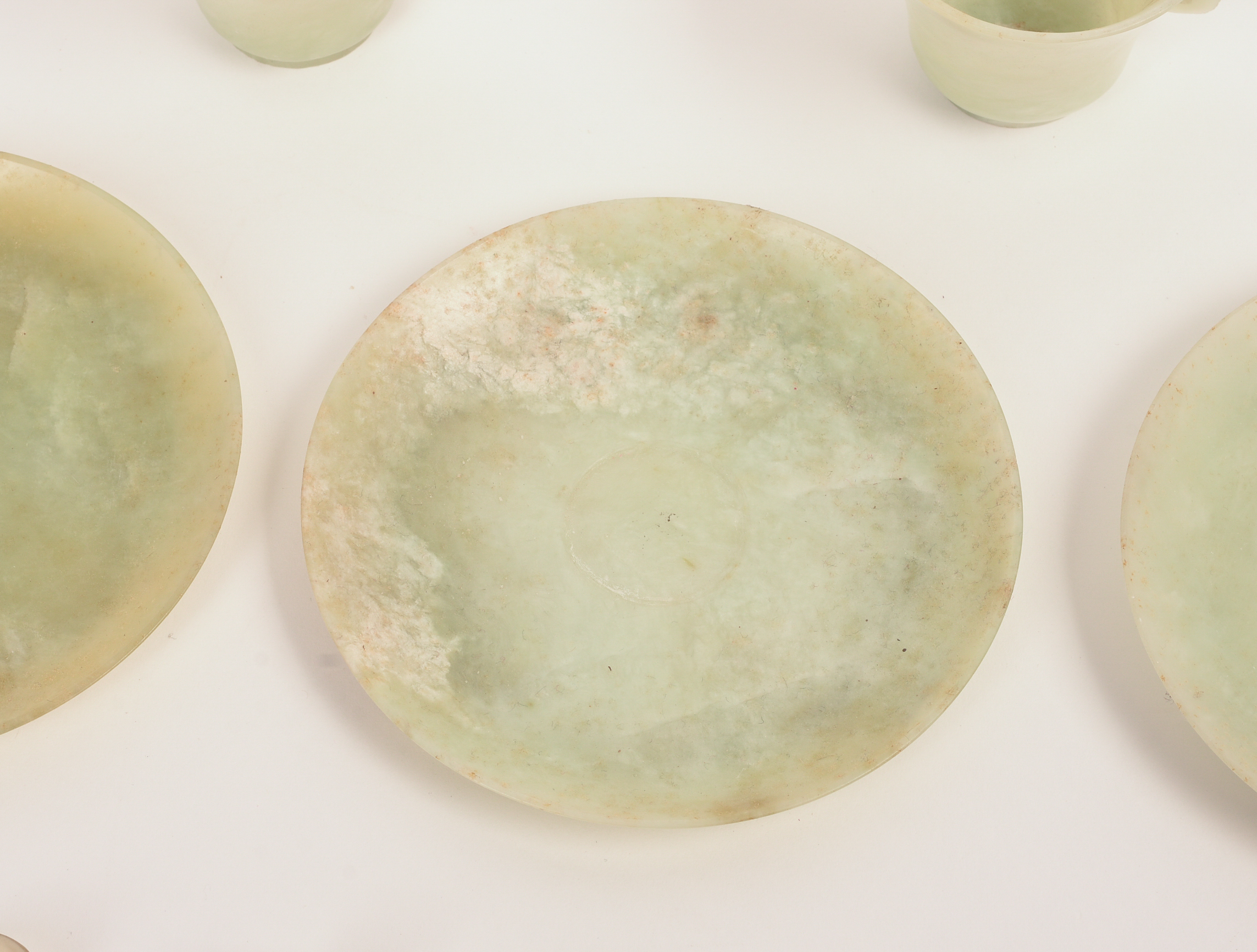 FOUR CHINESE JADE TEA CUPS, SAUCERS, AND SPOONS.