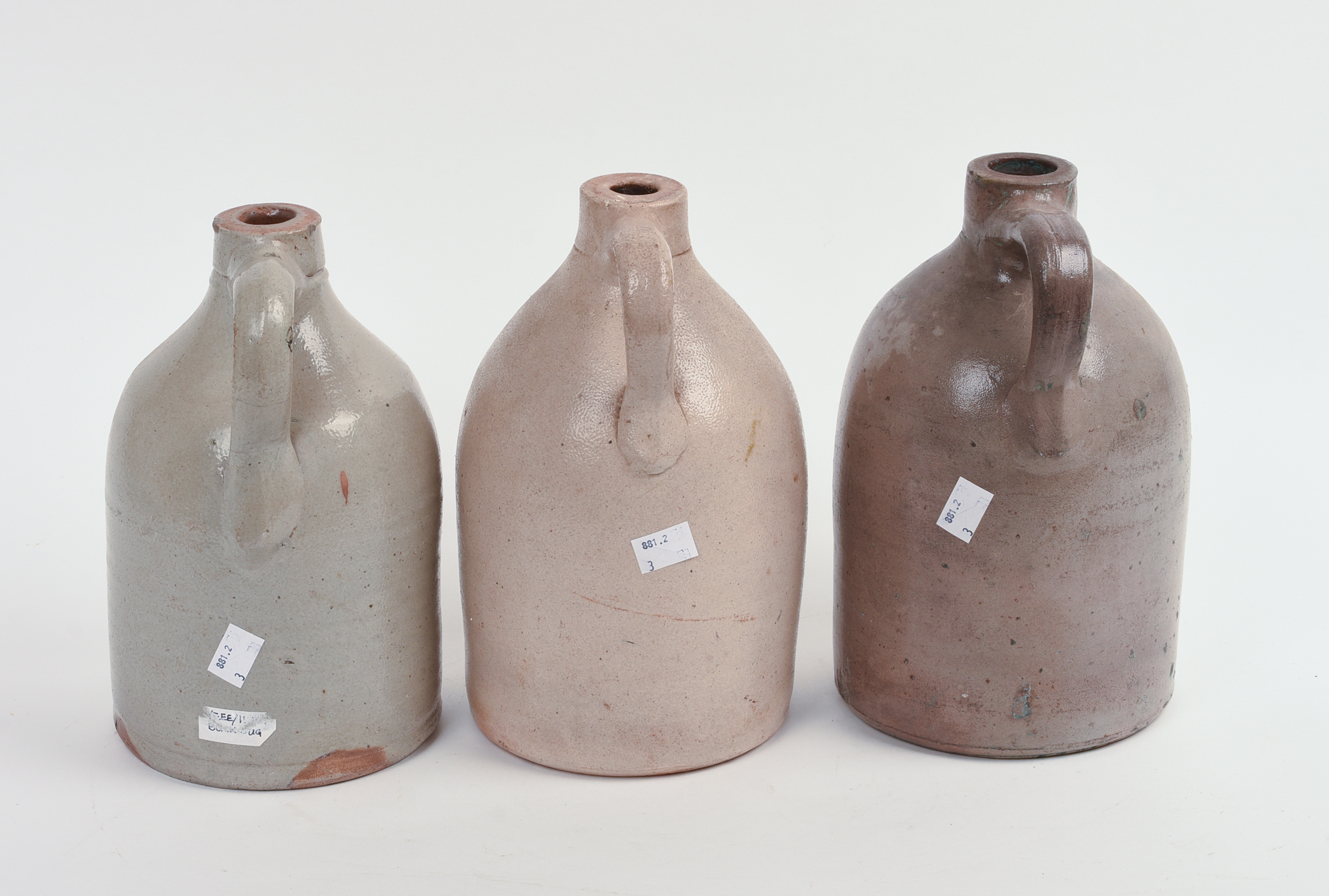 THREE SMALL STONEWARE JUGS.