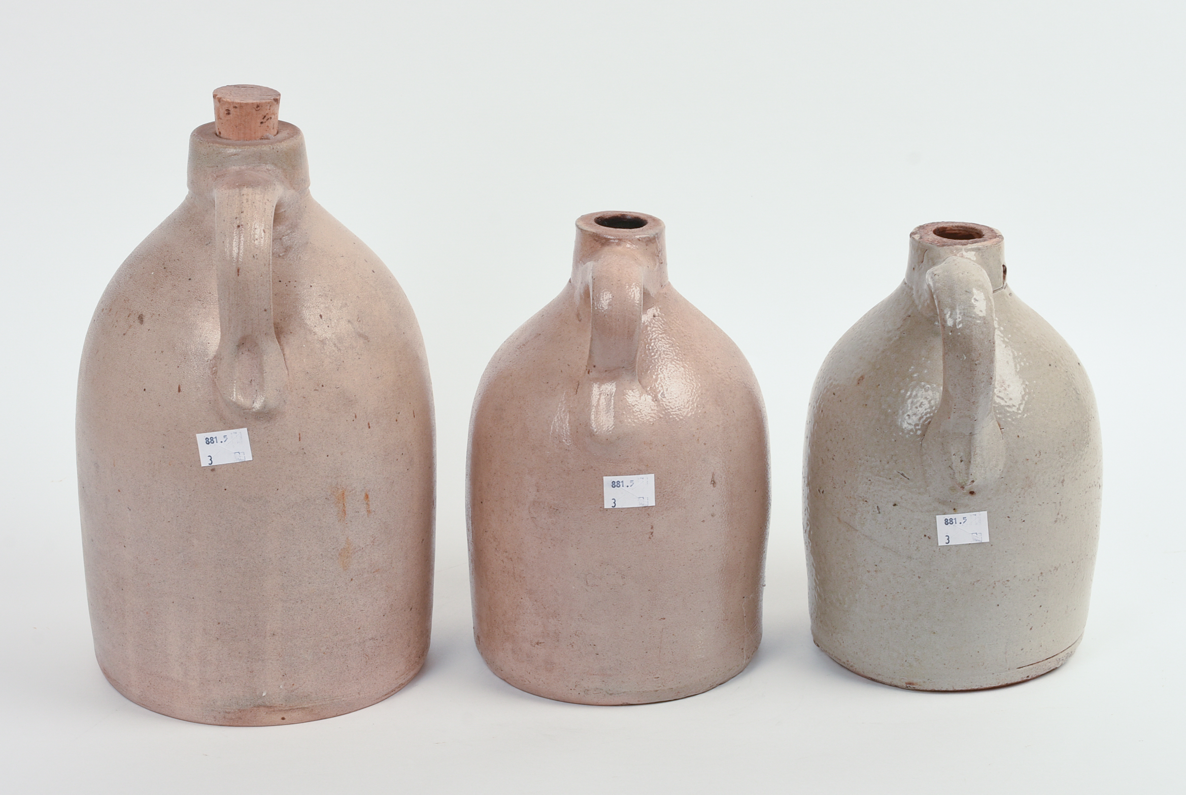 THREE STONEWARE JUGS.