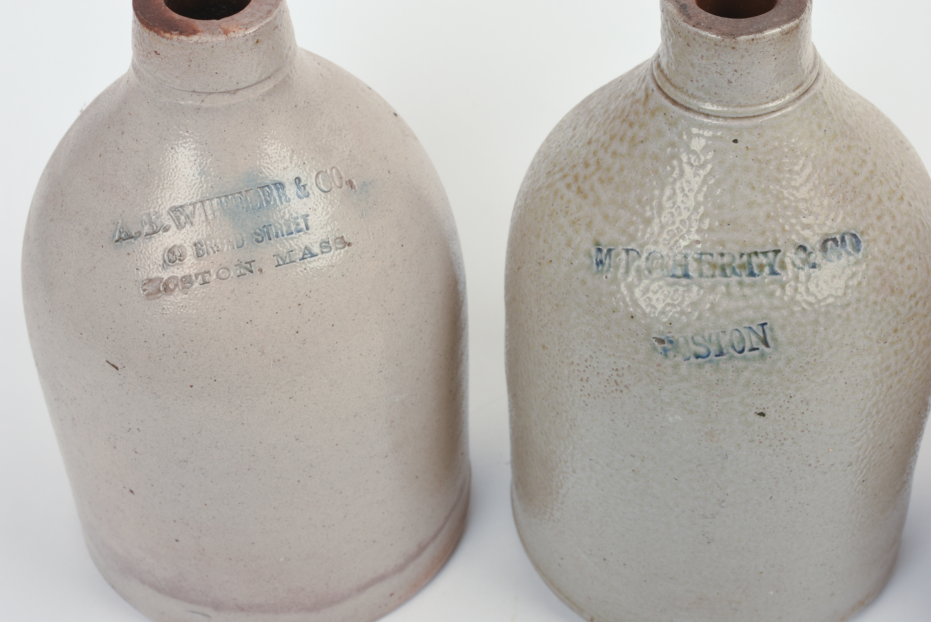 FOUR SMALL BOSTON STONEWARE JUGS.