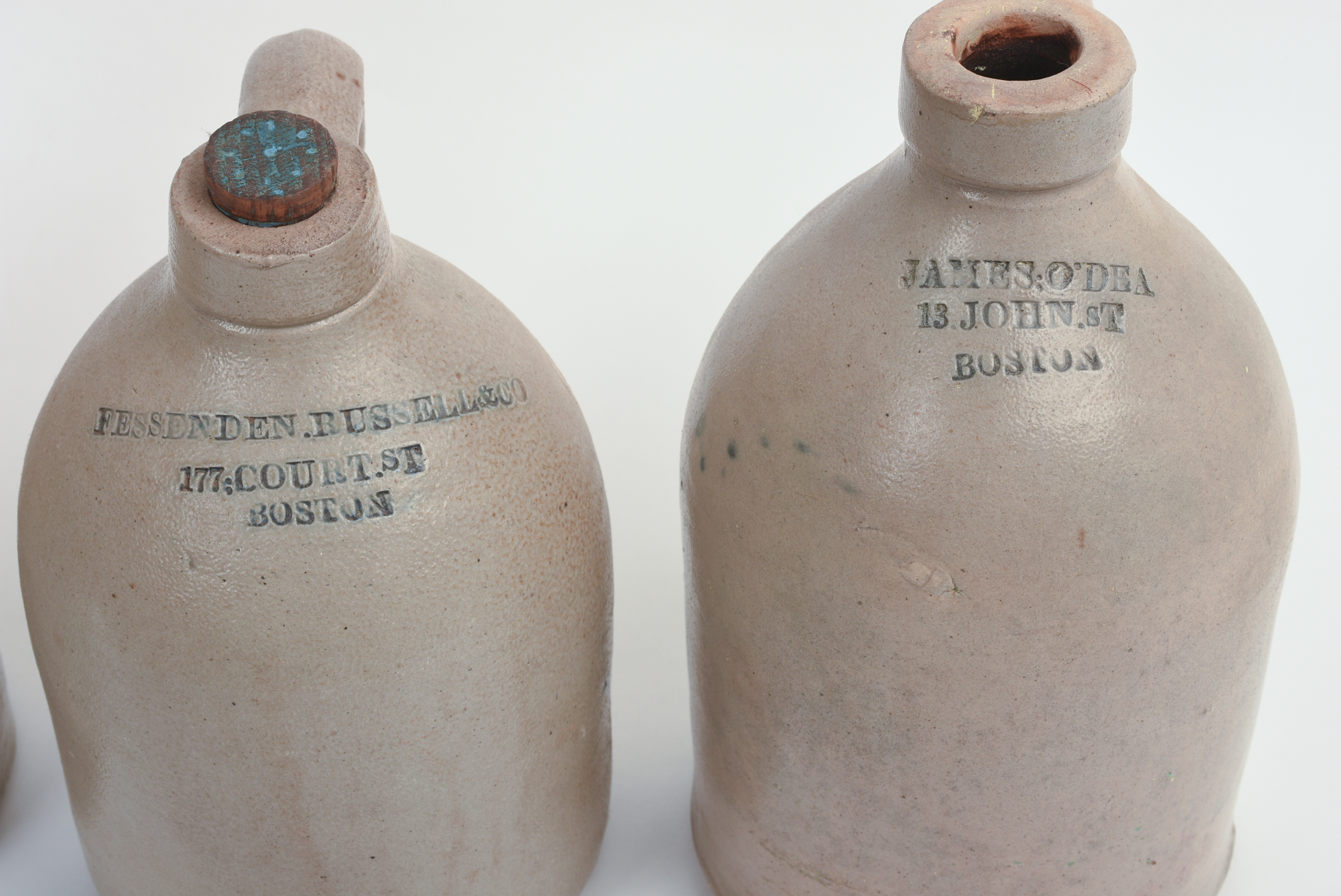 FOUR SMALL BOSTON STONEWARE JUGS.