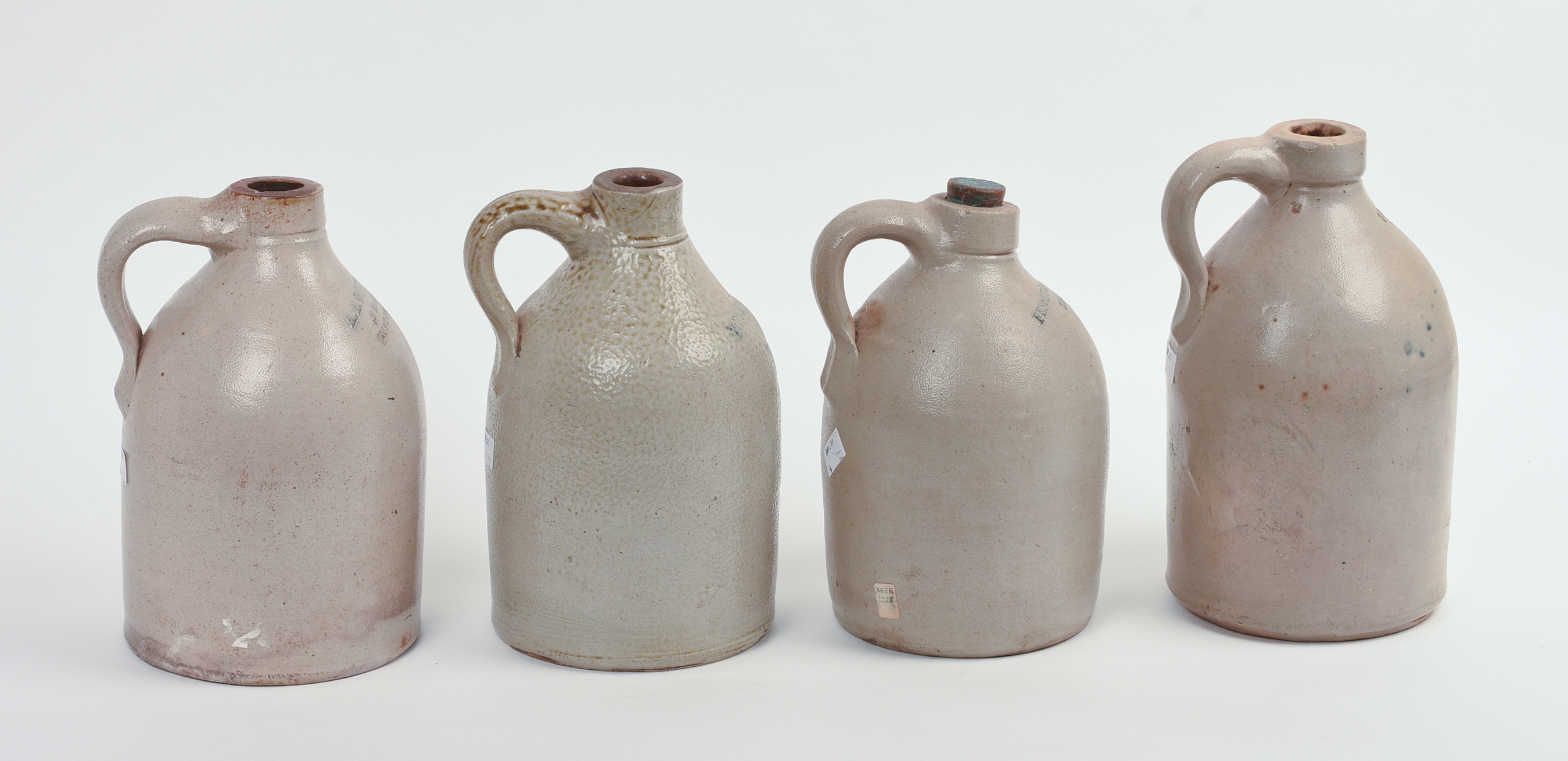 FOUR SMALL BOSTON STONEWARE JUGS.