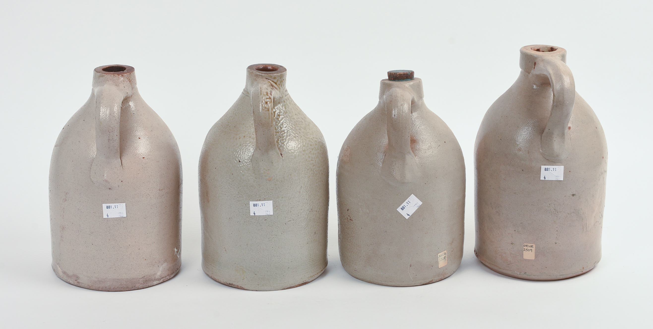 FOUR SMALL BOSTON STONEWARE JUGS.