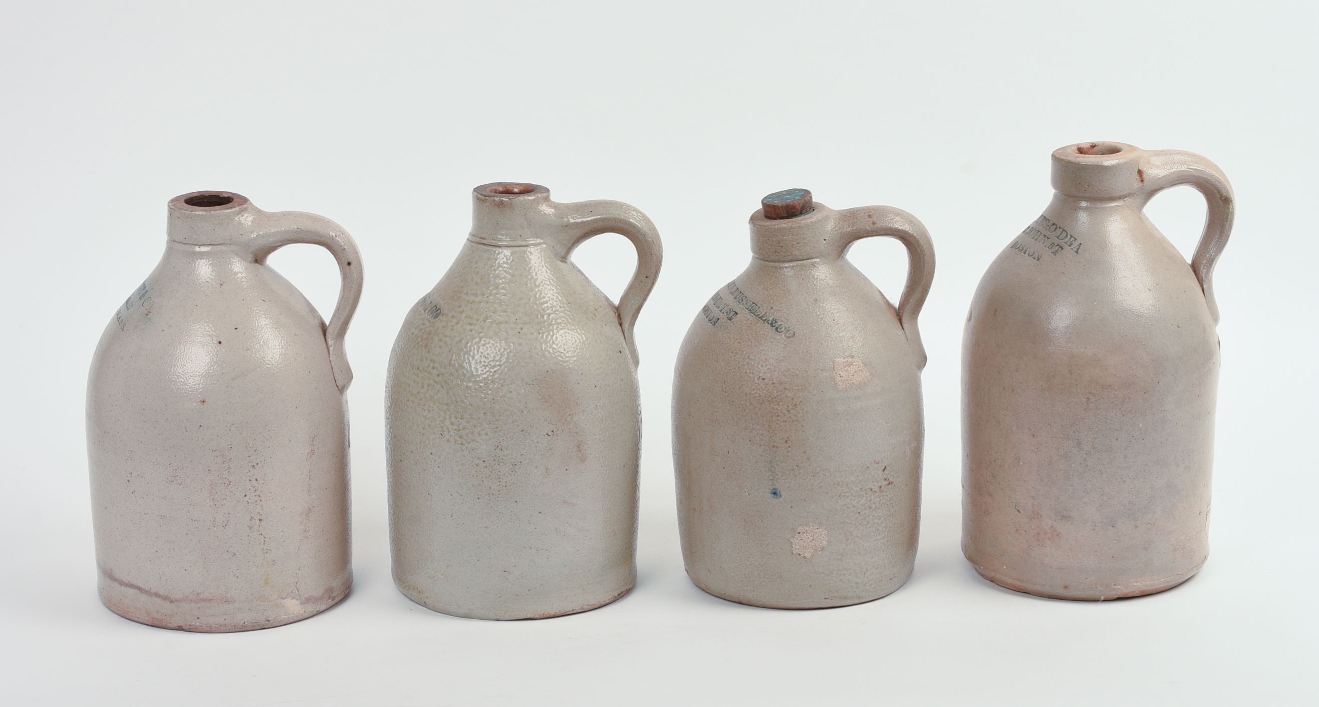FOUR SMALL BOSTON STONEWARE JUGS.