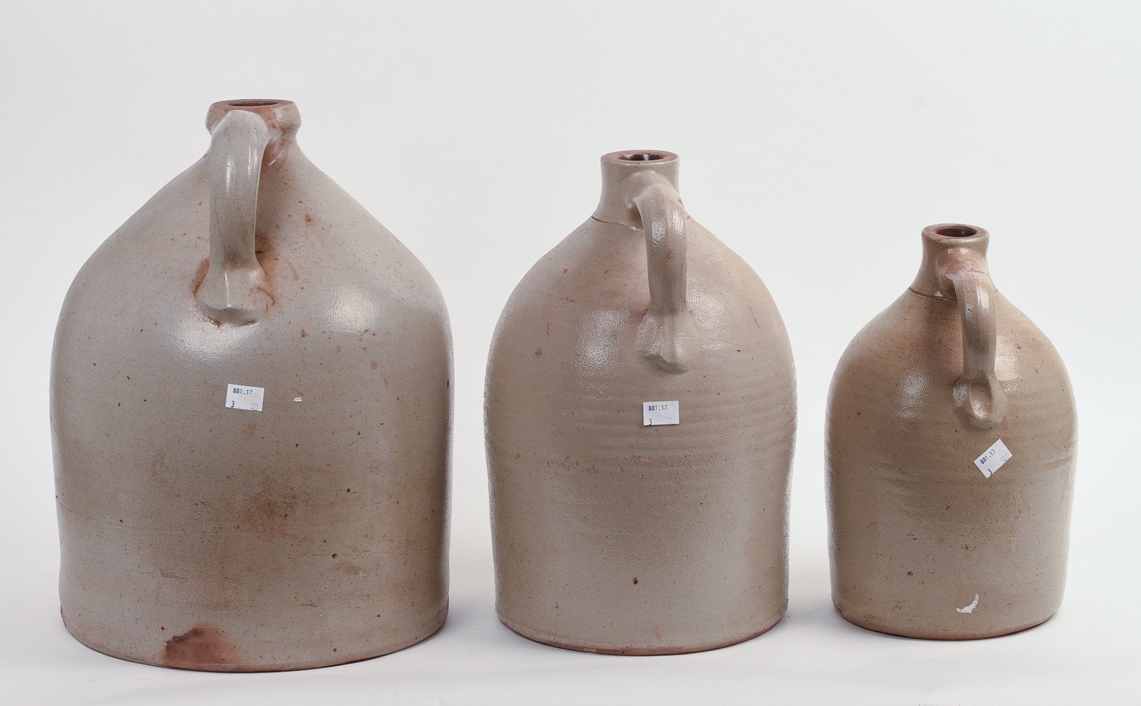 THREE STONEWARE JUGS.