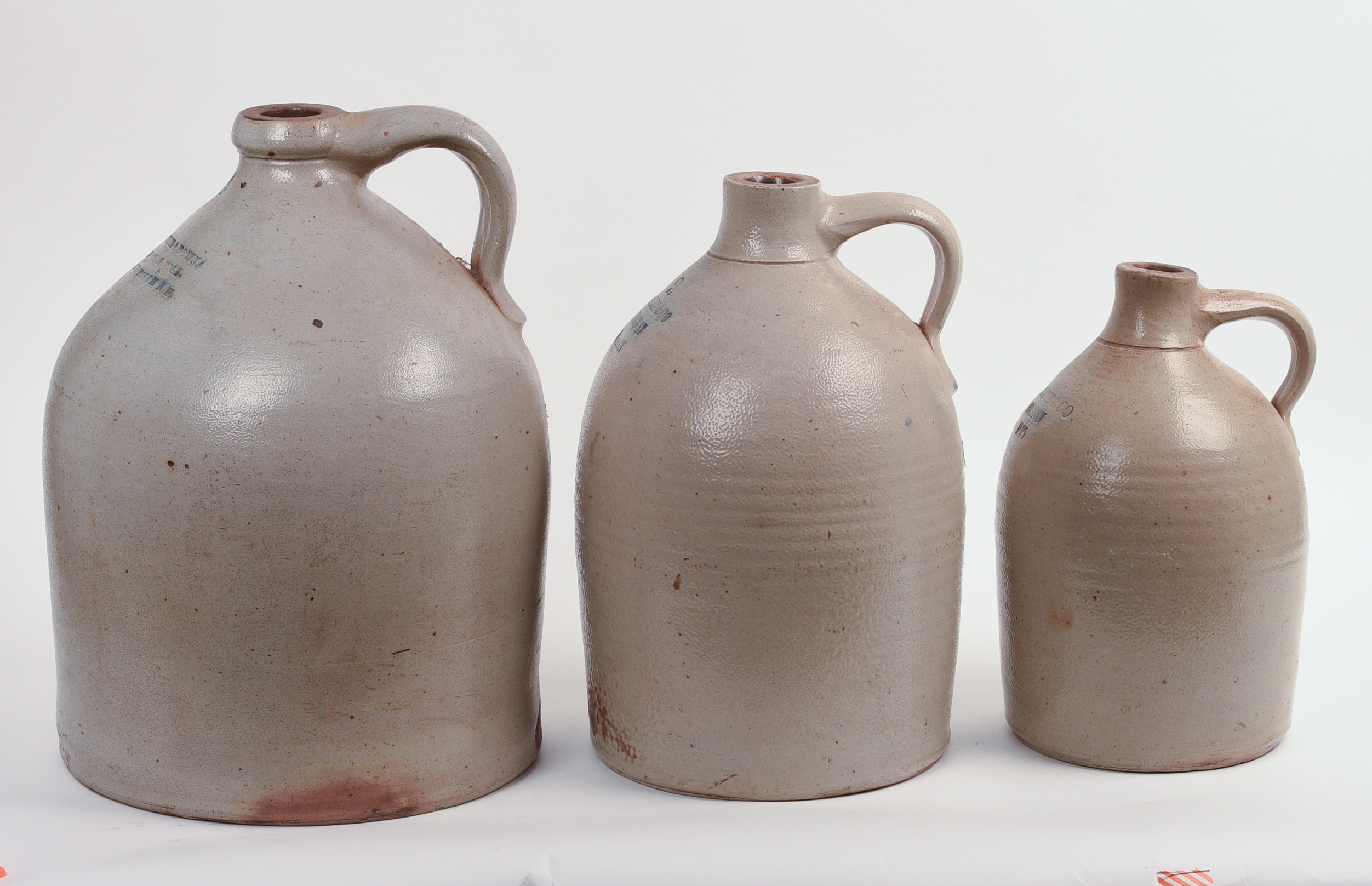 THREE STONEWARE JUGS.