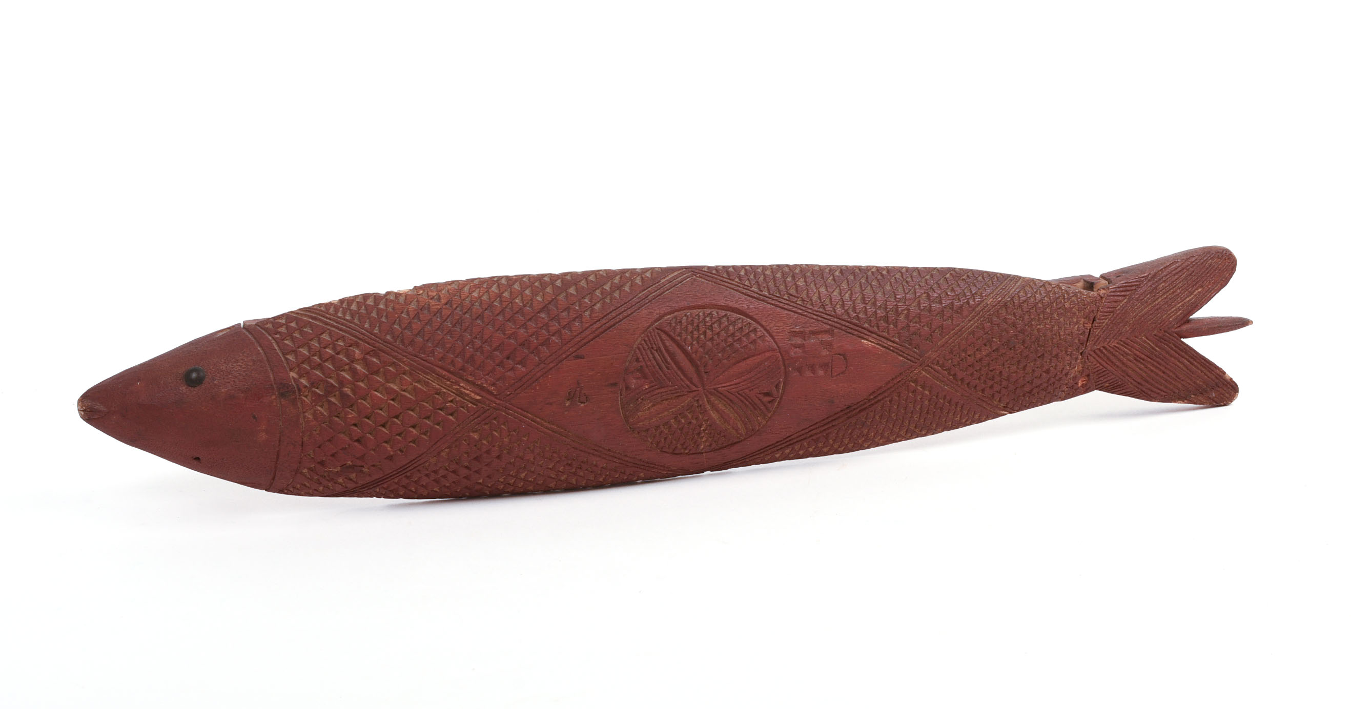CHIP-CARVED FISH IN RED PAINT.