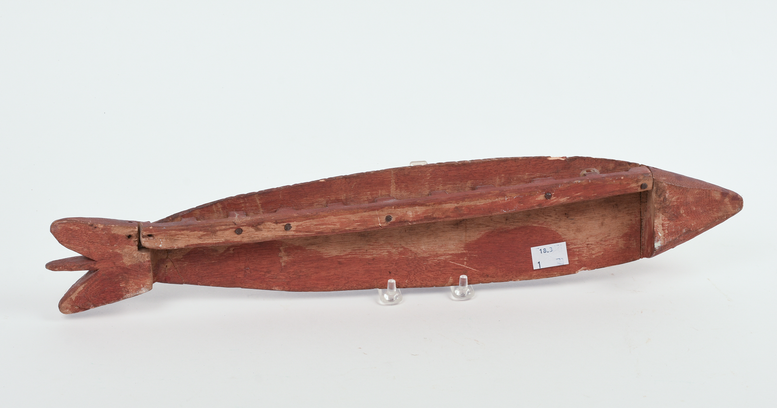 CHIP-CARVED FISH IN RED PAINT.