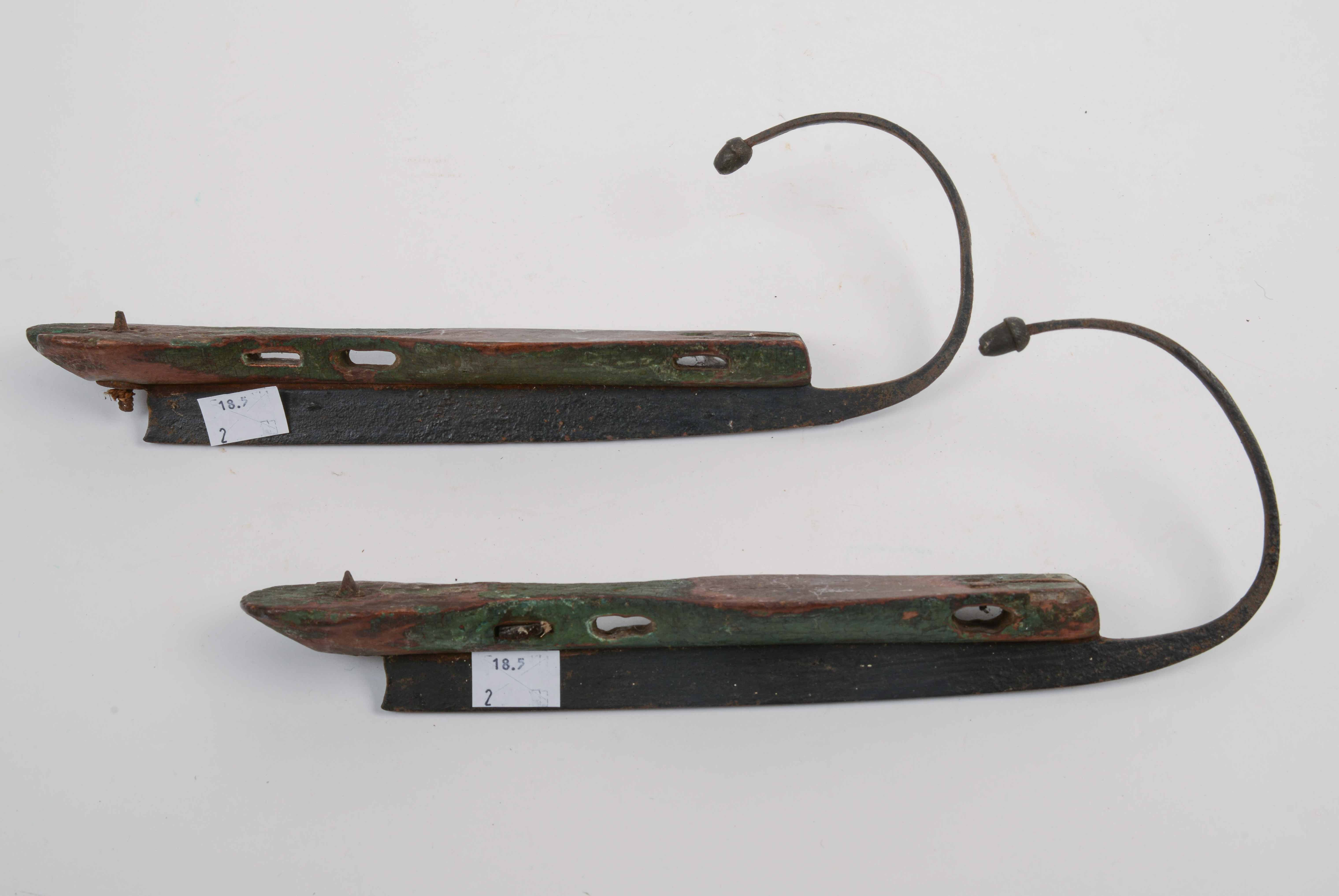 19TH CENTURY STEEL-AND-WOOD ICE SKATES.