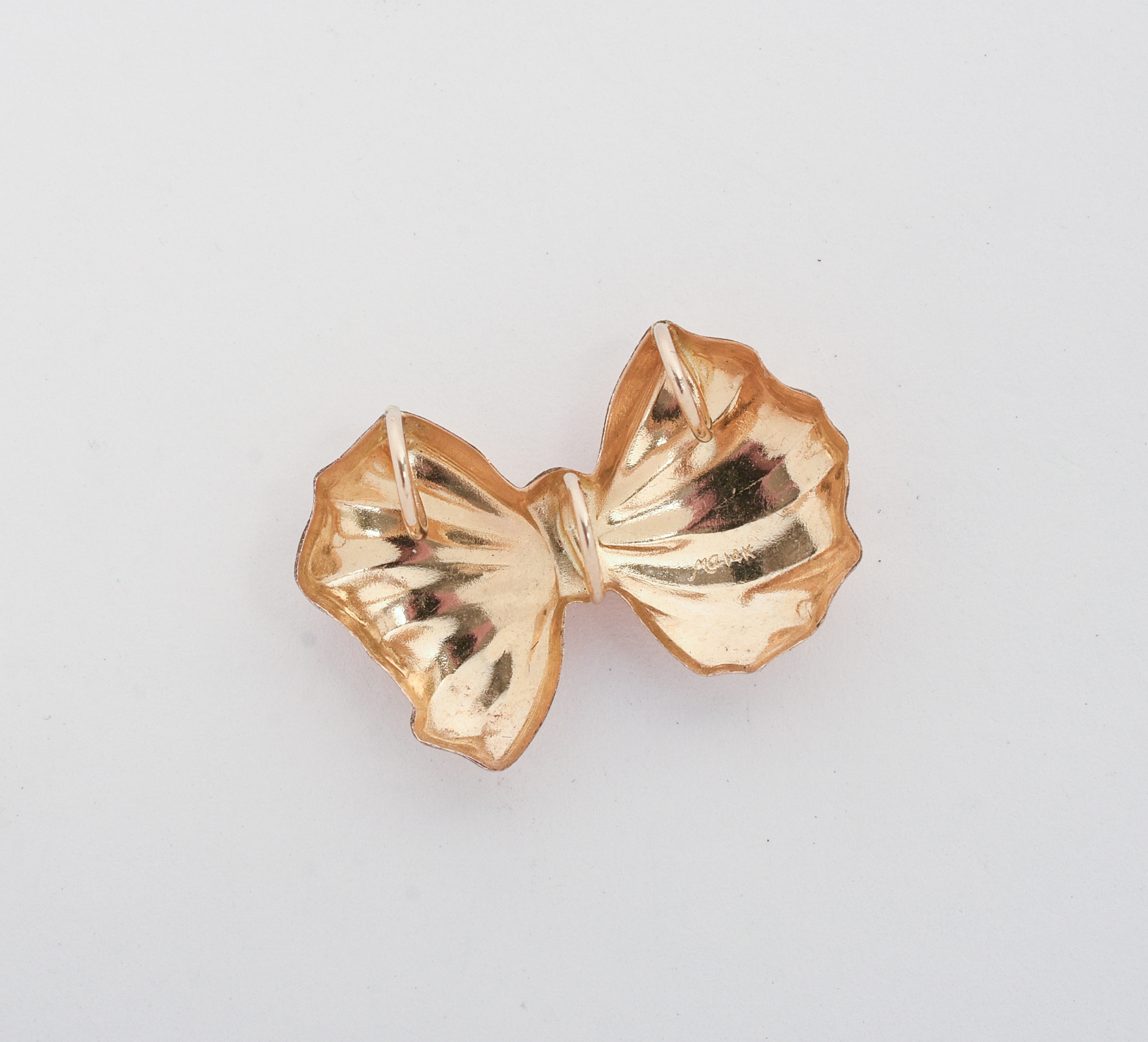MARC ANTHONY 14K GOLD BOW PENDANT.
