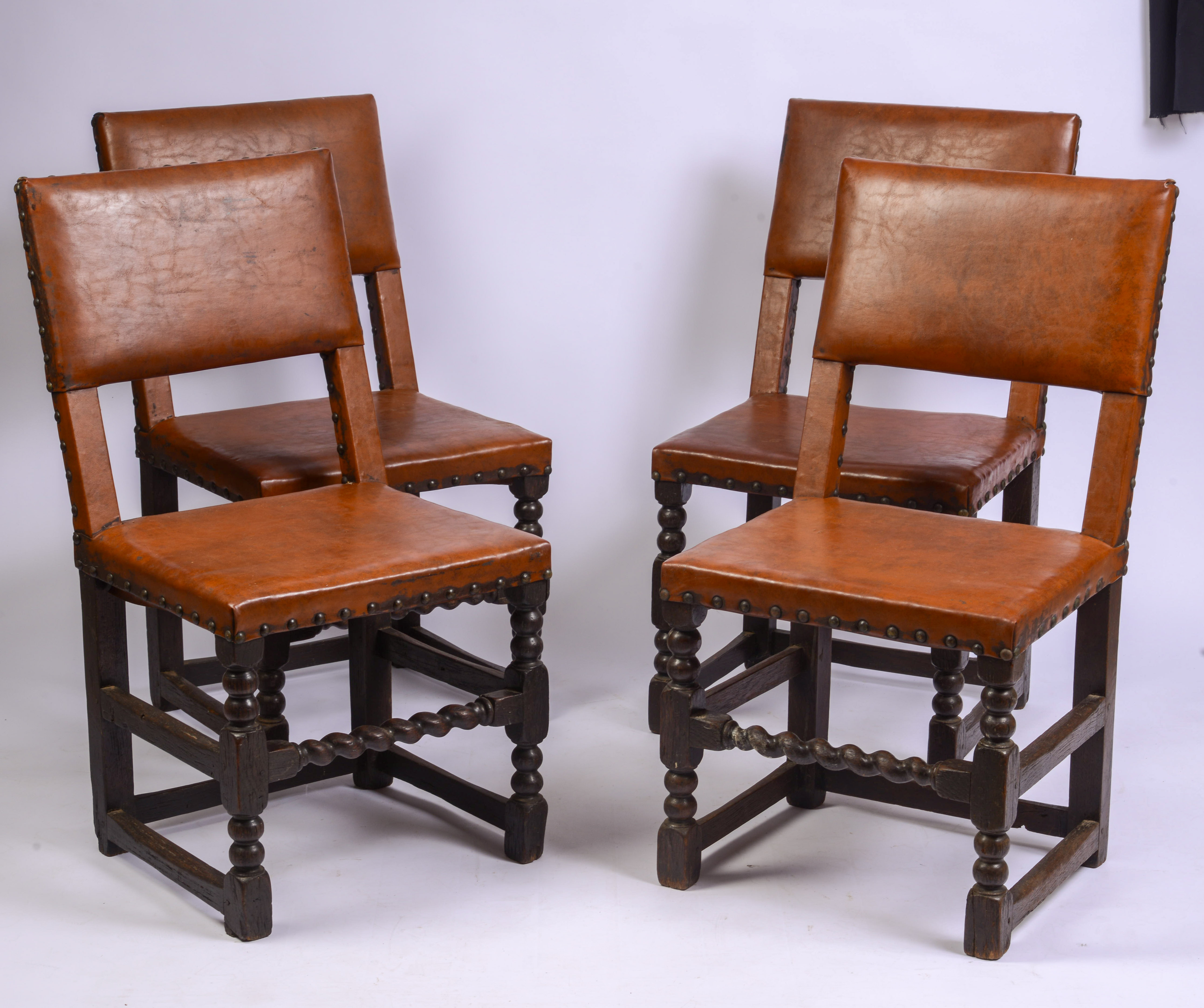SCARCE SET OF FOUR, MID-17TH CENTURY LEATHER BACK STOOLS.