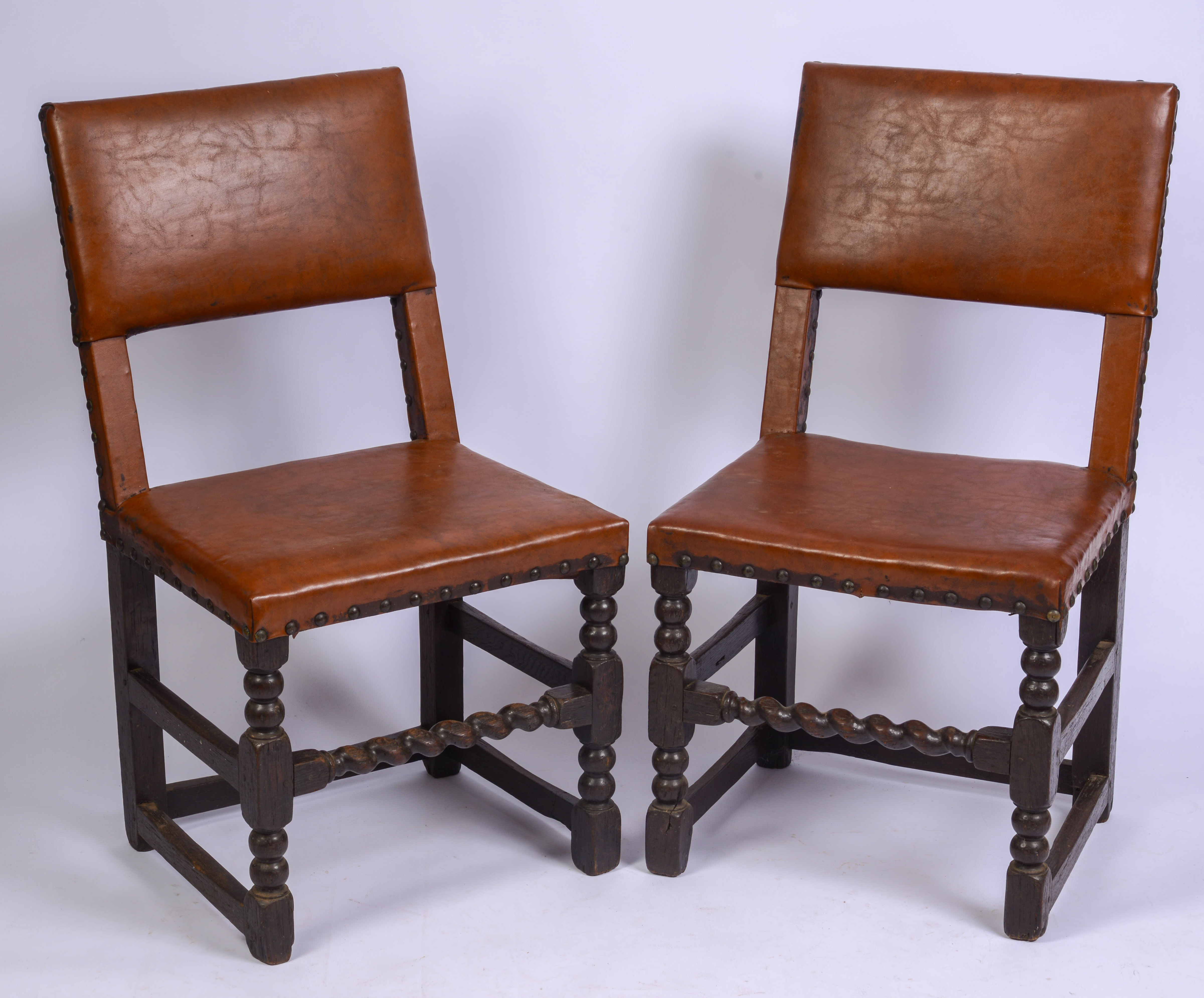 SCARCE SET OF FOUR, MID-17TH CENTURY LEATHER BACK STOOLS.