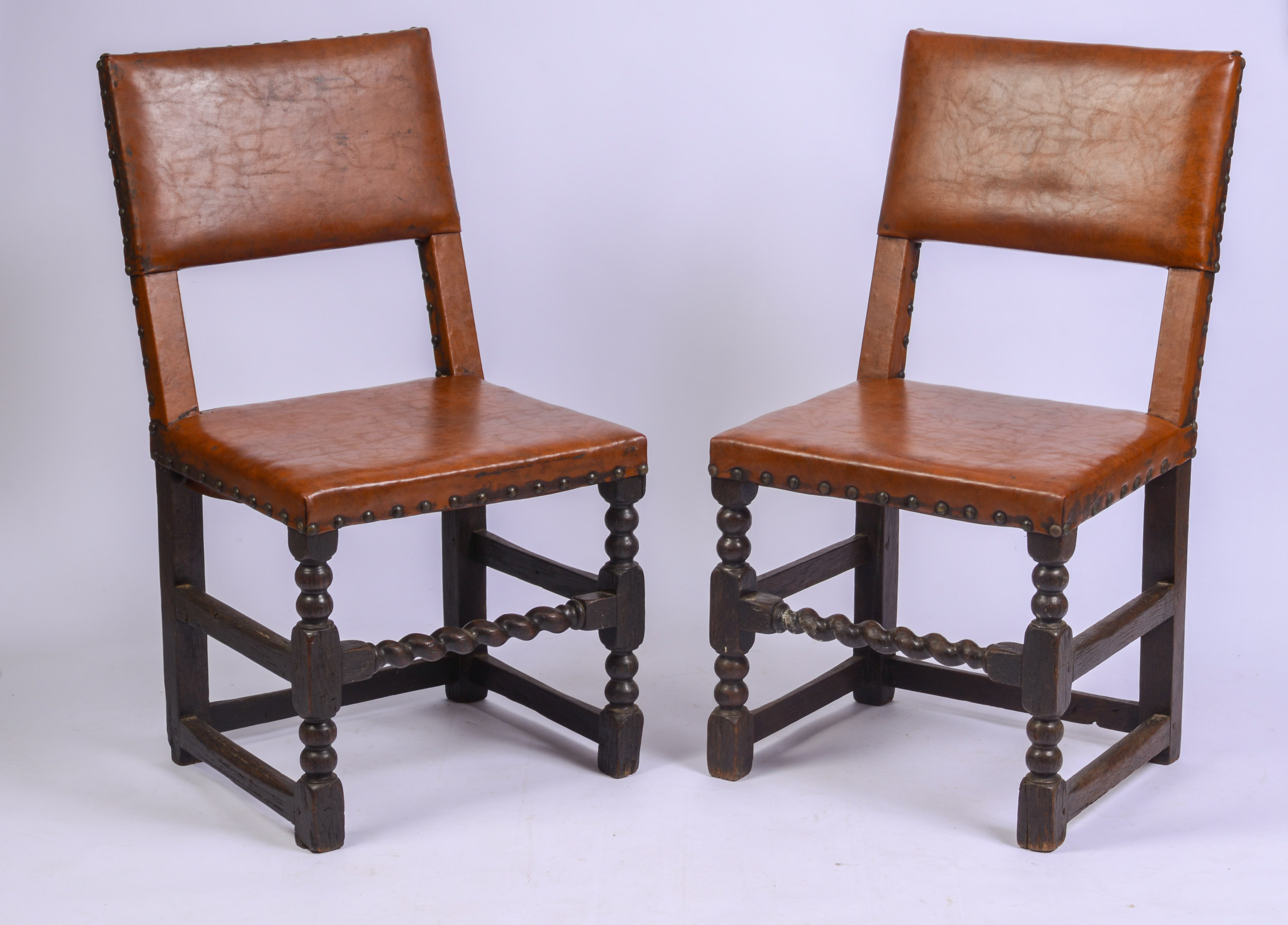SCARCE SET OF FOUR, MID-17TH CENTURY LEATHER BACK STOOLS.