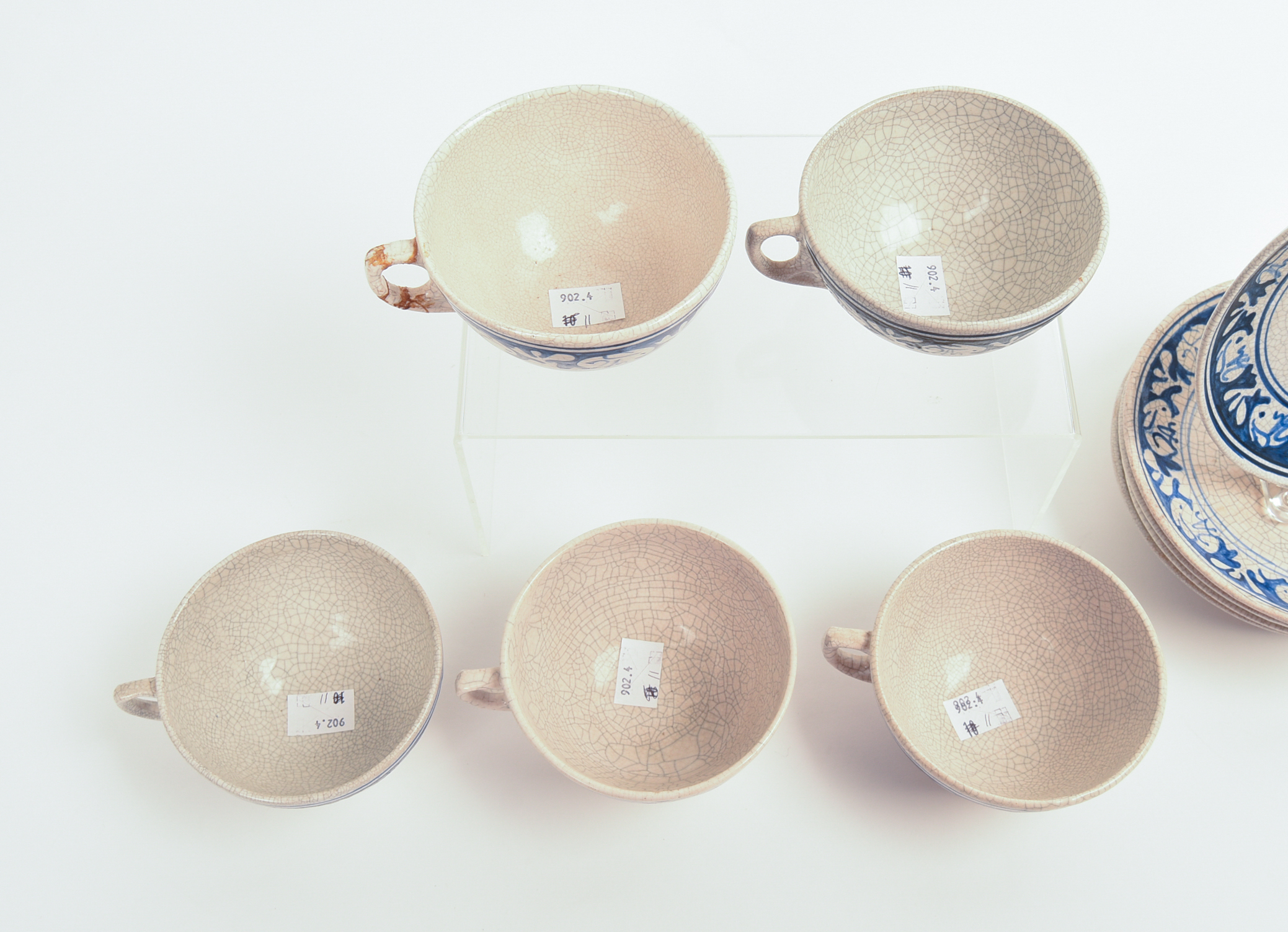 FIVE DEDHAM POTTERY RABBIT PATTERN TEACUPS AND SAUCERS AND A MUG