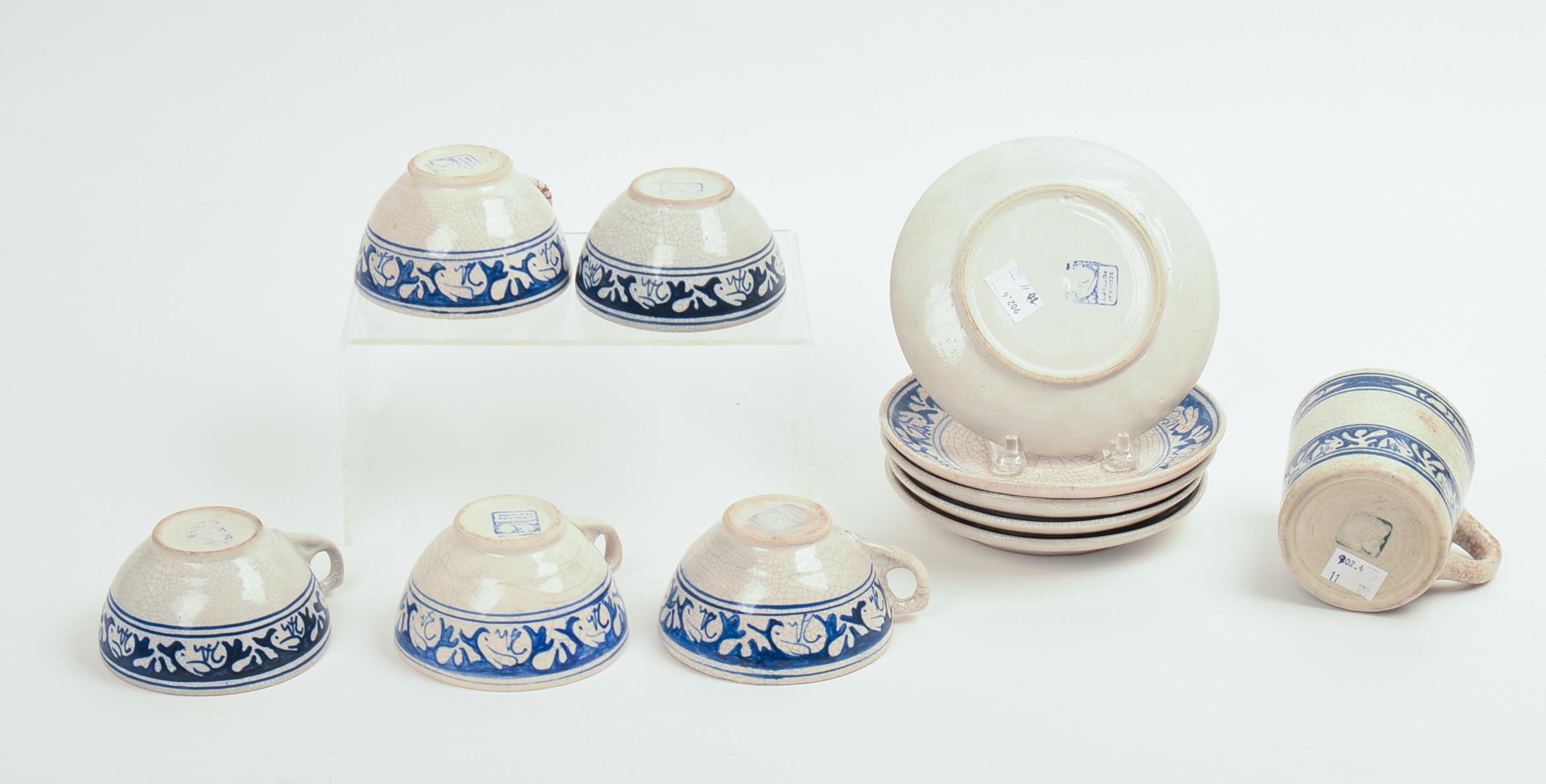 FIVE DEDHAM POTTERY RABBIT PATTERN TEACUPS AND SAUCERS AND A MUG