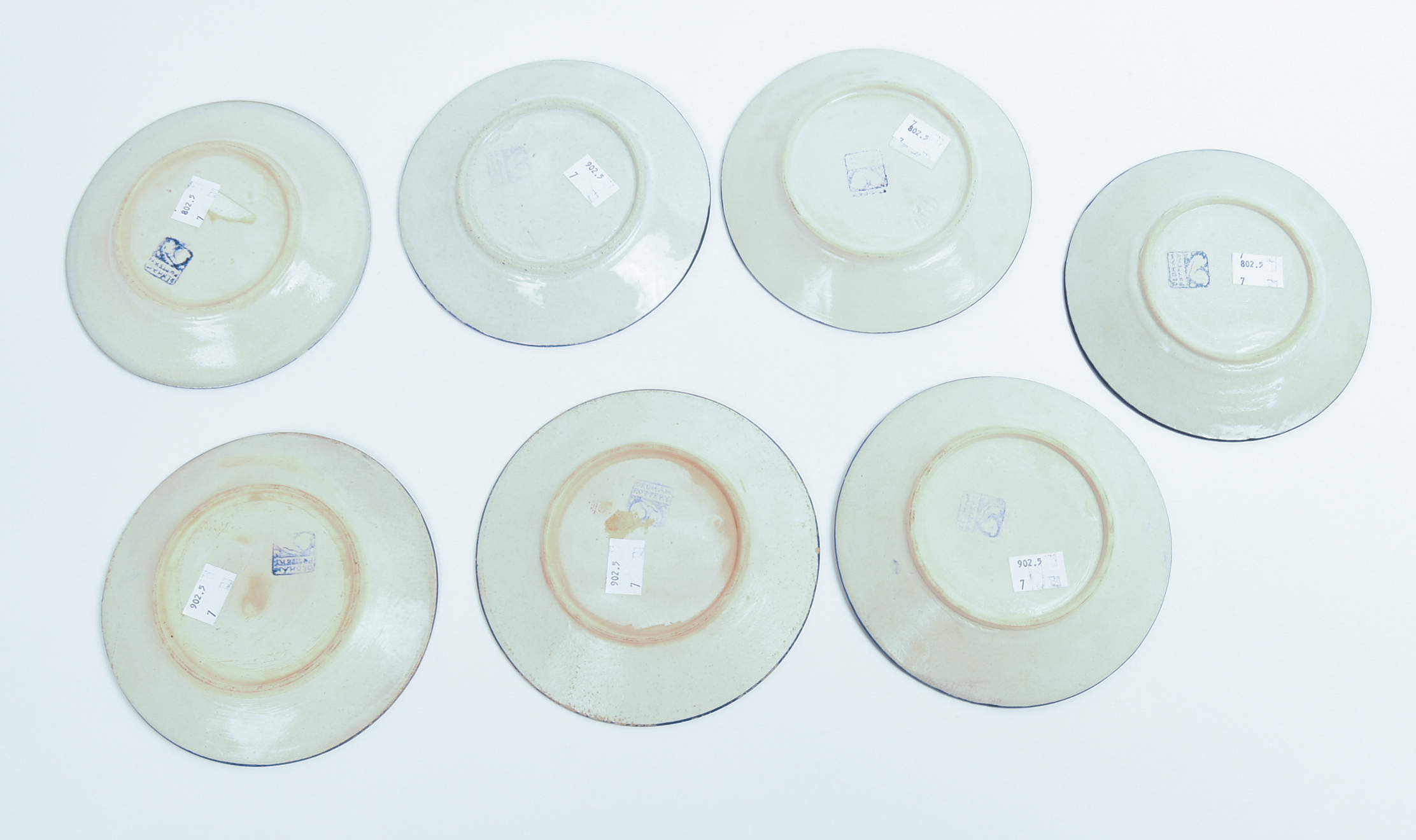SEVEN SMALL DEDHAM POTTERY PLATES.
