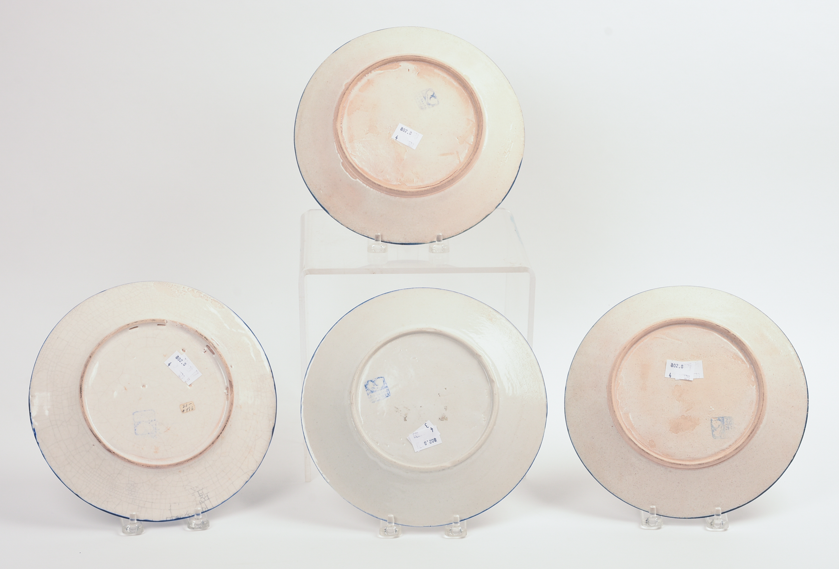 FOUR DEDHAM POTTERY FLORAL PATTERN PLATES.