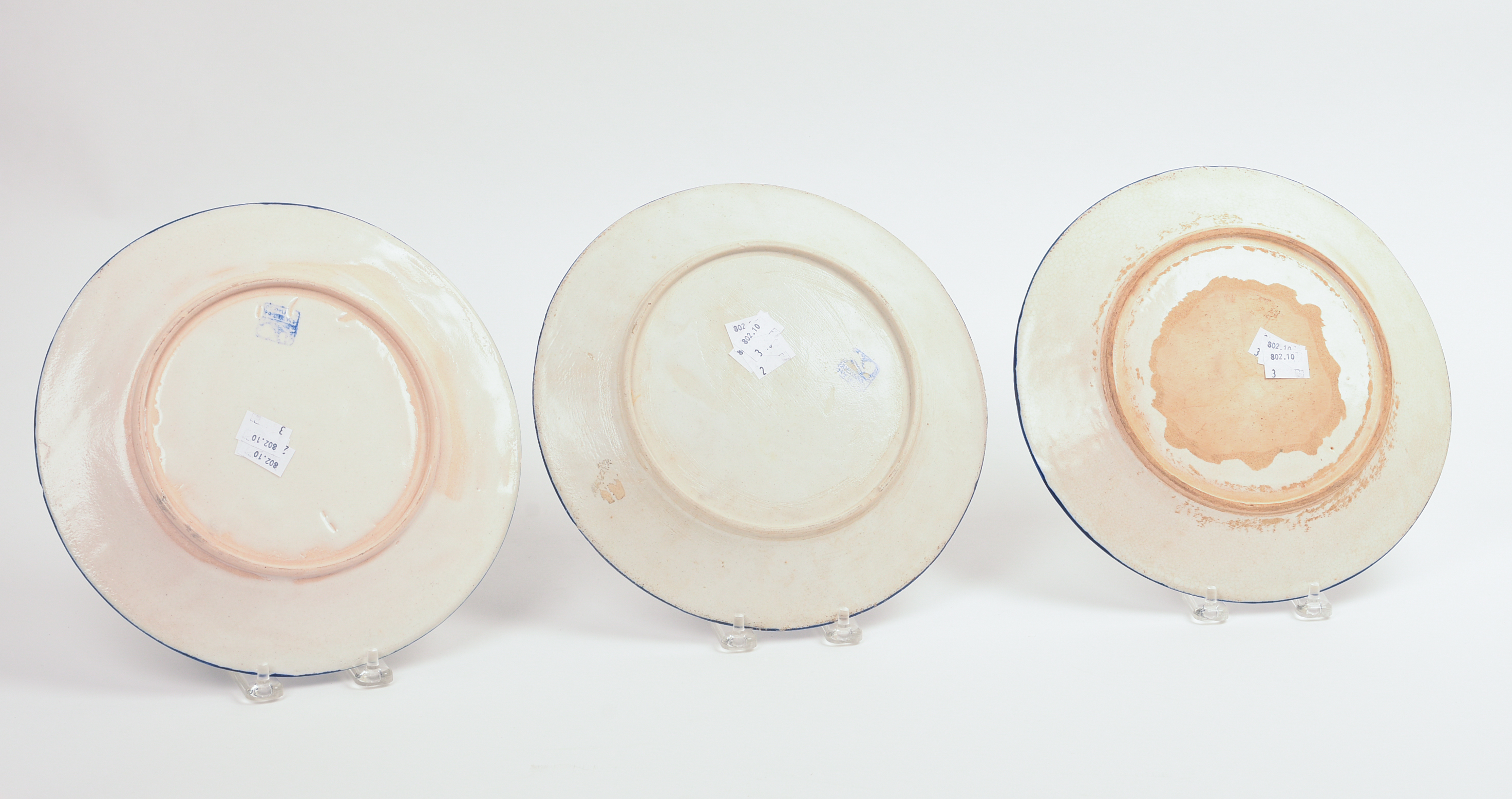 THREE DEDHAM POTTERY PLATES.