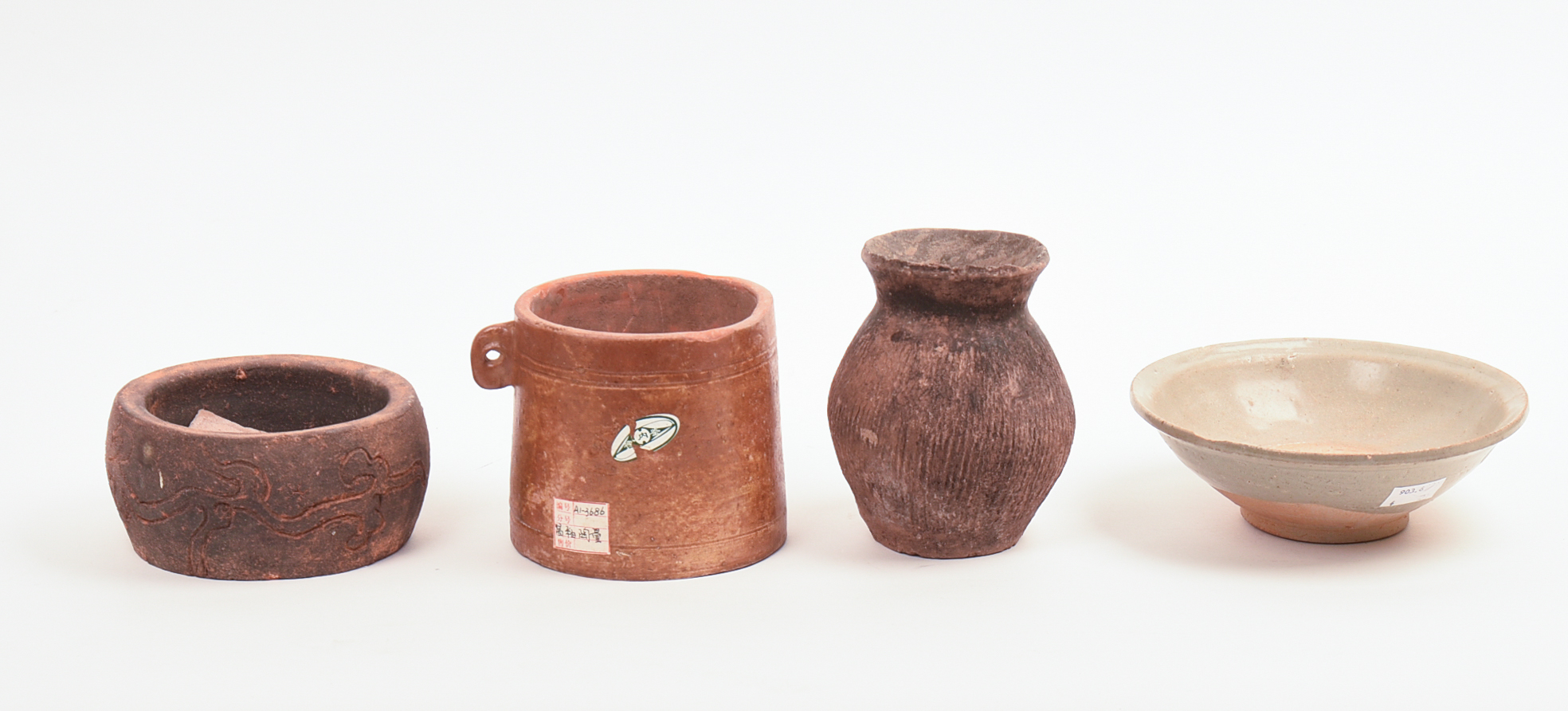 FOUR EARLY CHINESE CERAMIC PIECES.