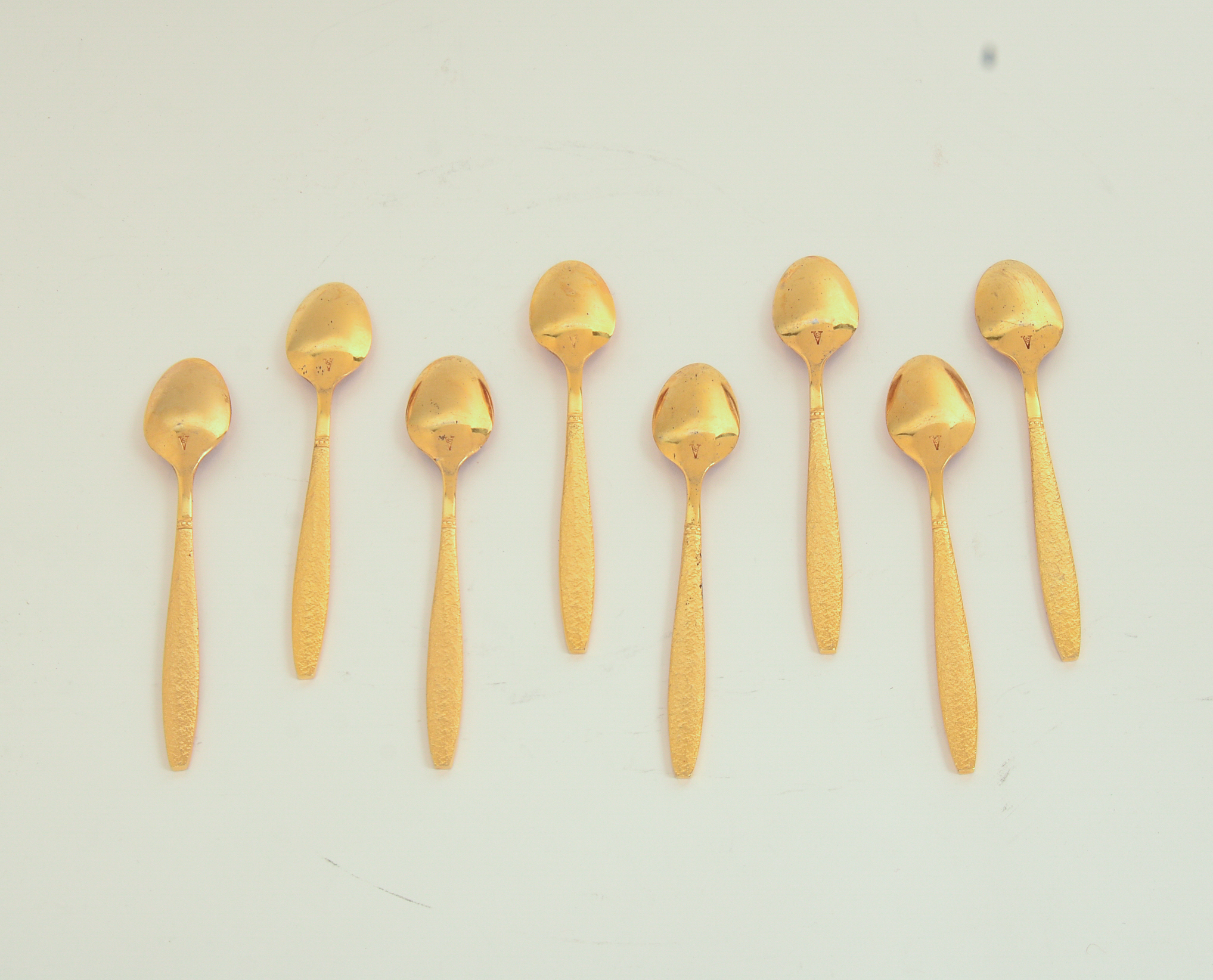 Eight Gold Wash Demitasse Spoons.
