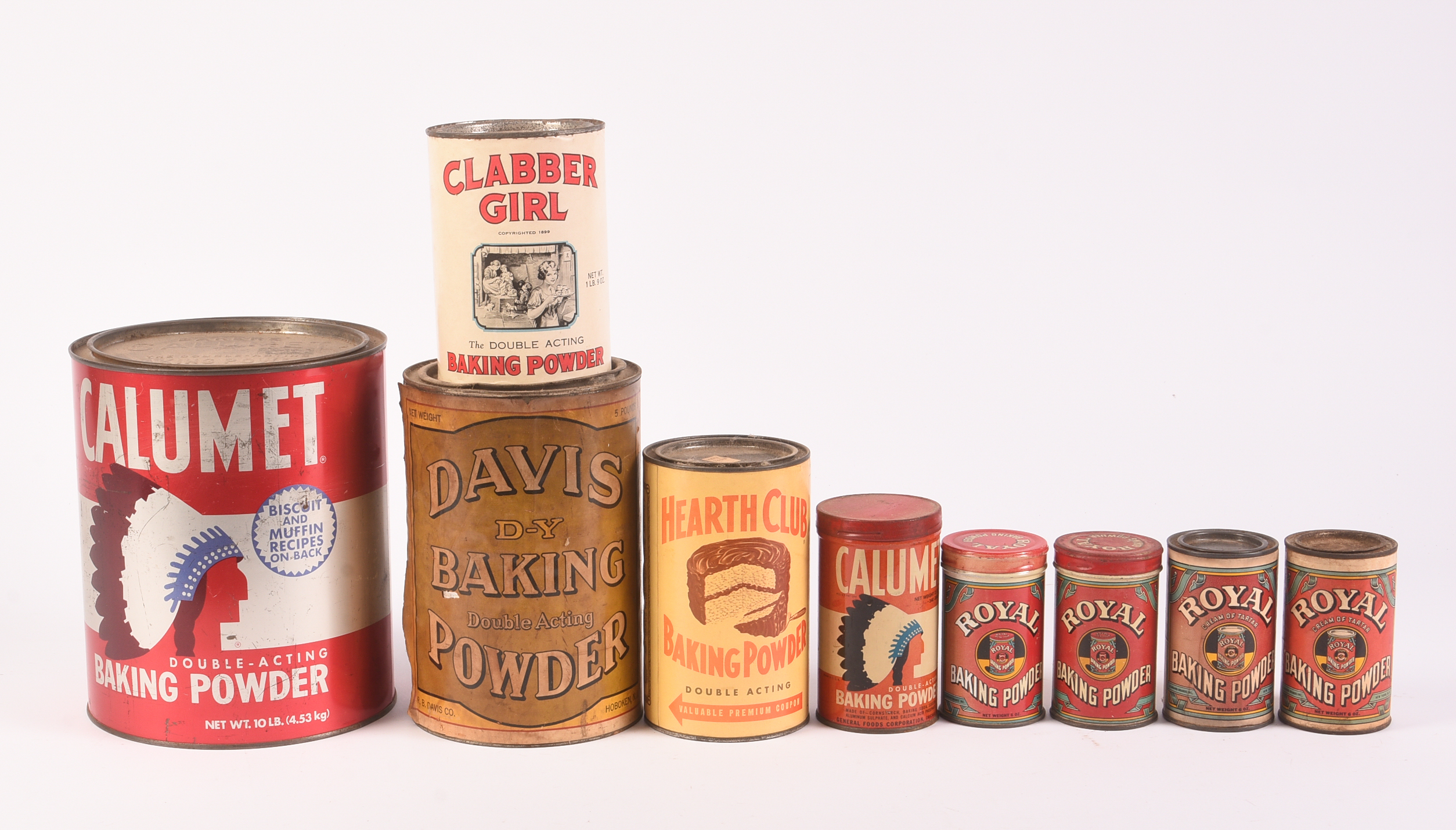 Nine Vitnage Baking Powder Tins.