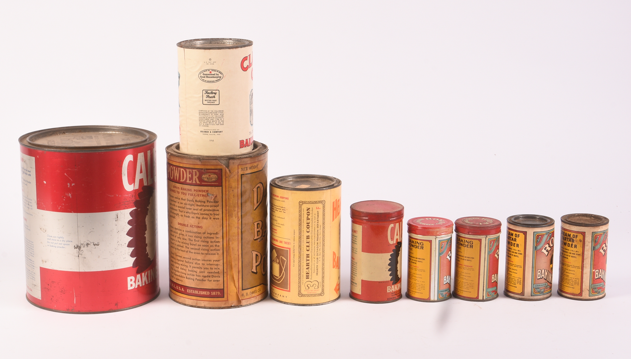Nine Vitnage Baking Powder Tins.