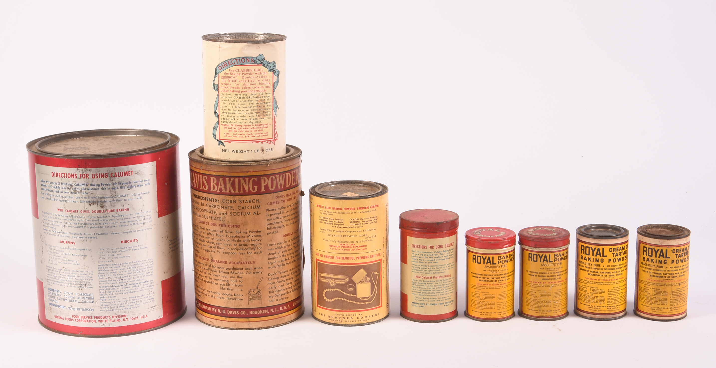 Nine Vitnage Baking Powder Tins.