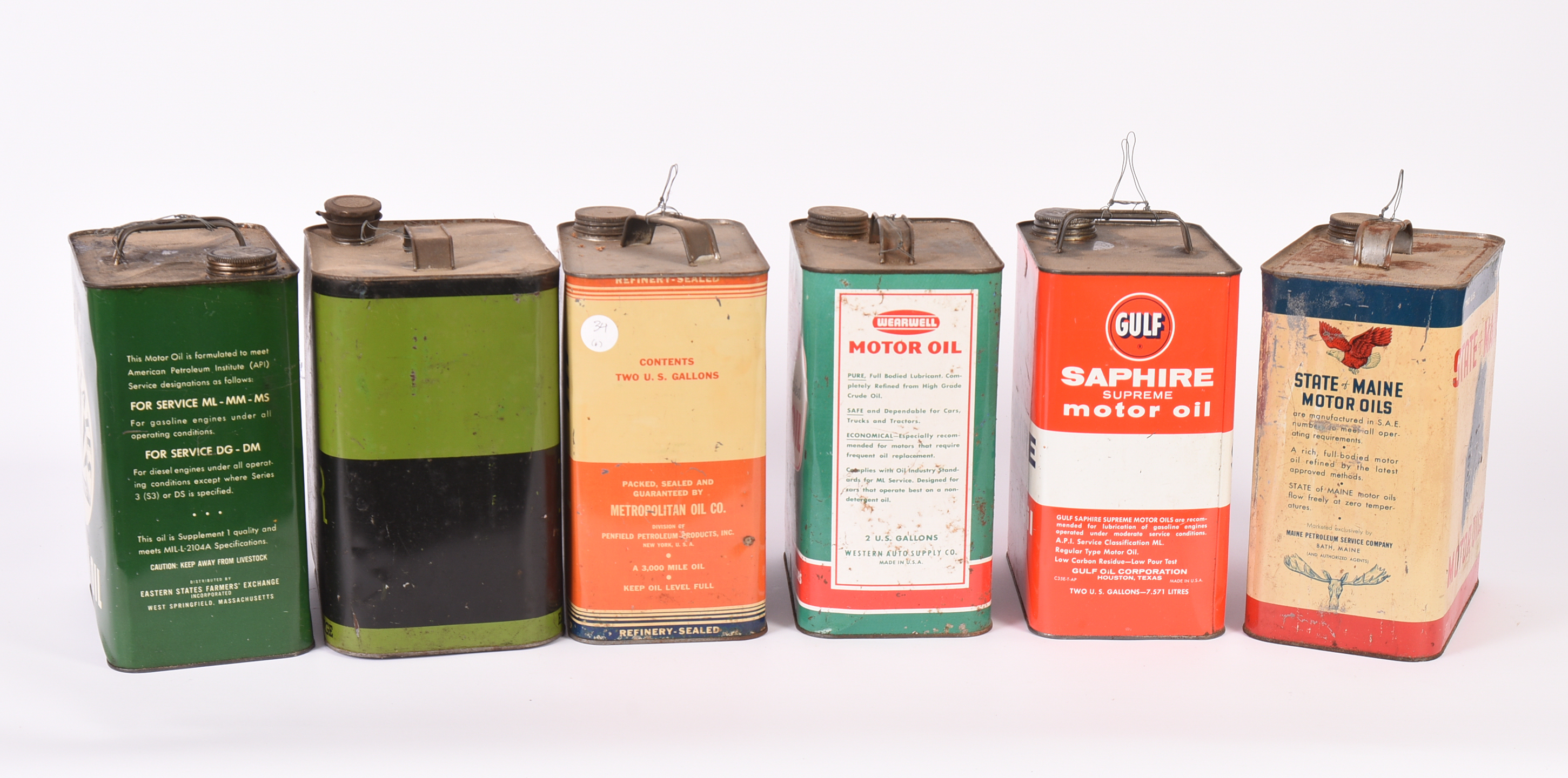 Six Vintage Motor Oil Cans.