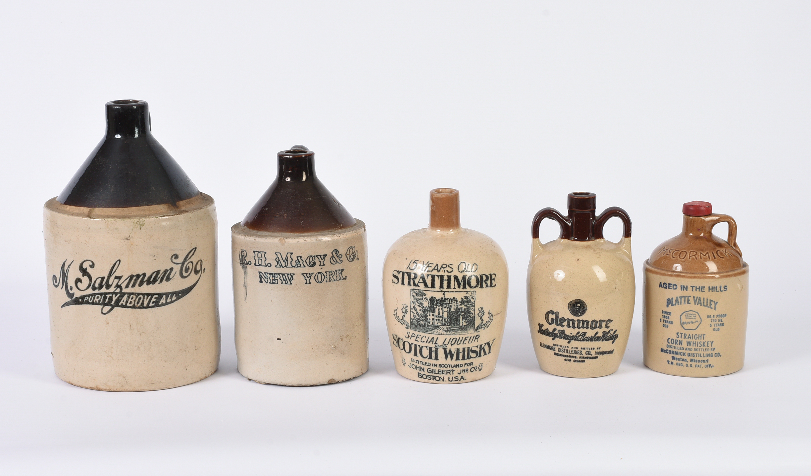 Five Stoneware Advertising Jugs.
