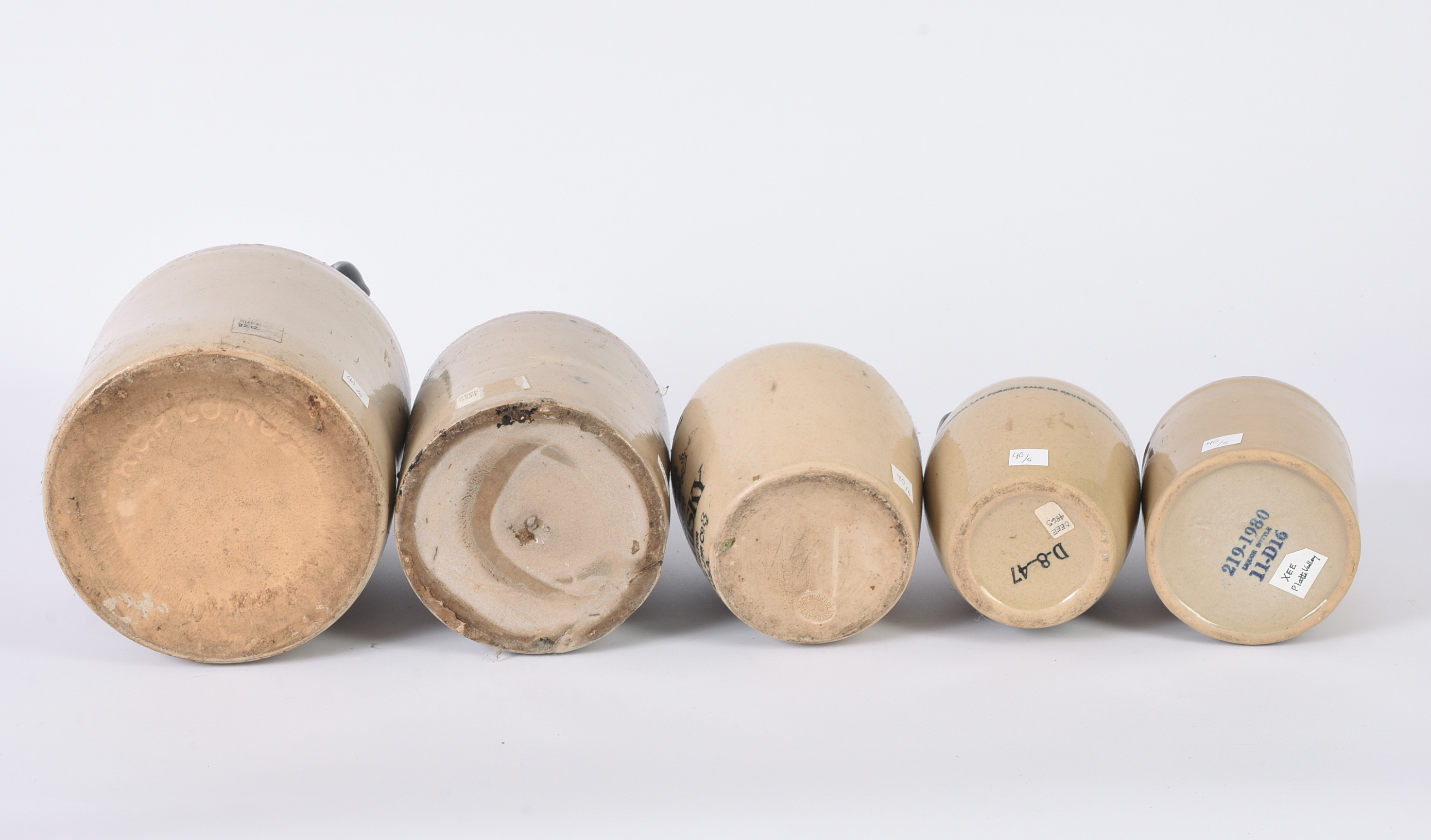 Five Stoneware Advertising Jugs.