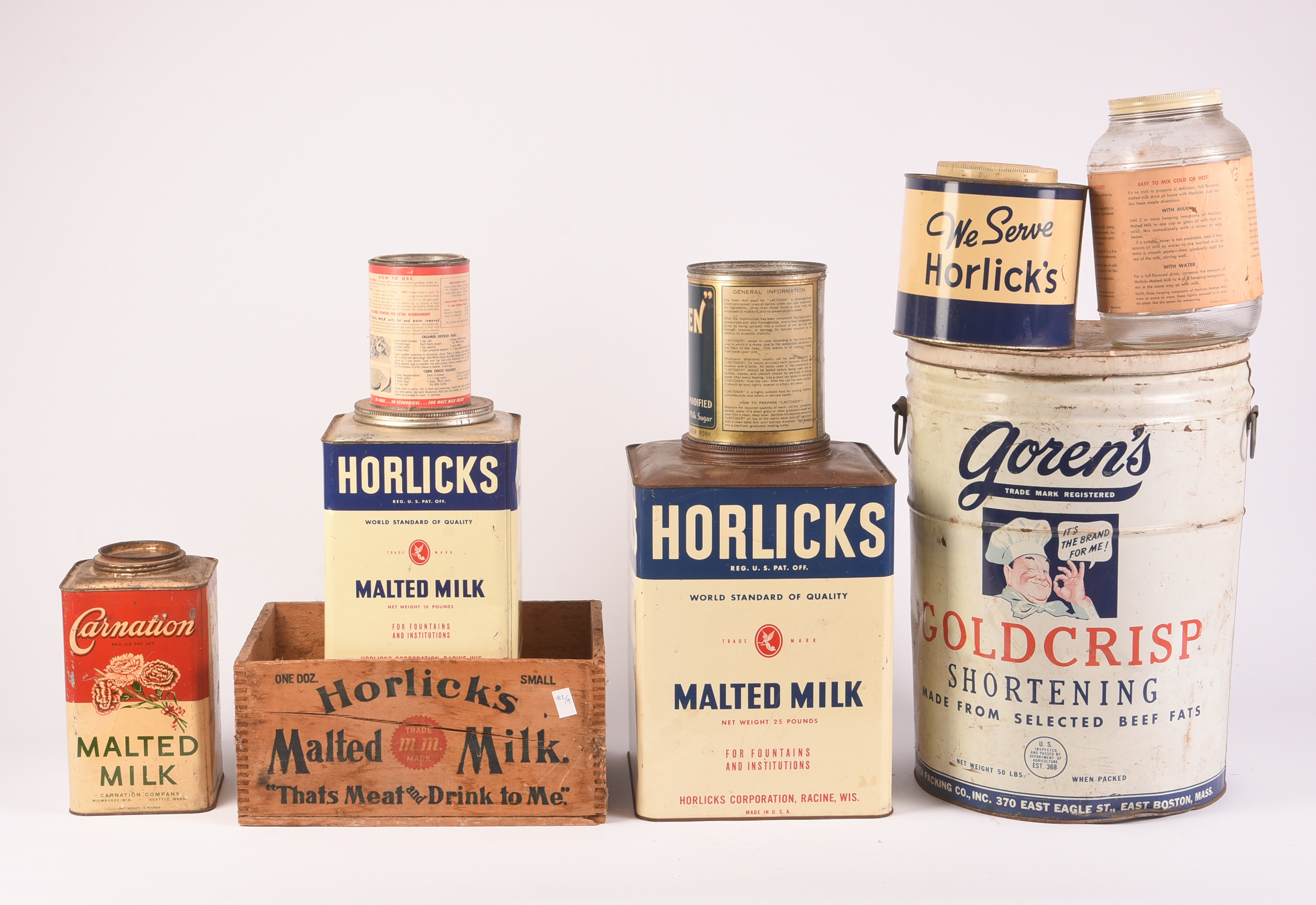 Eight Milk Related Advertising Containers.
