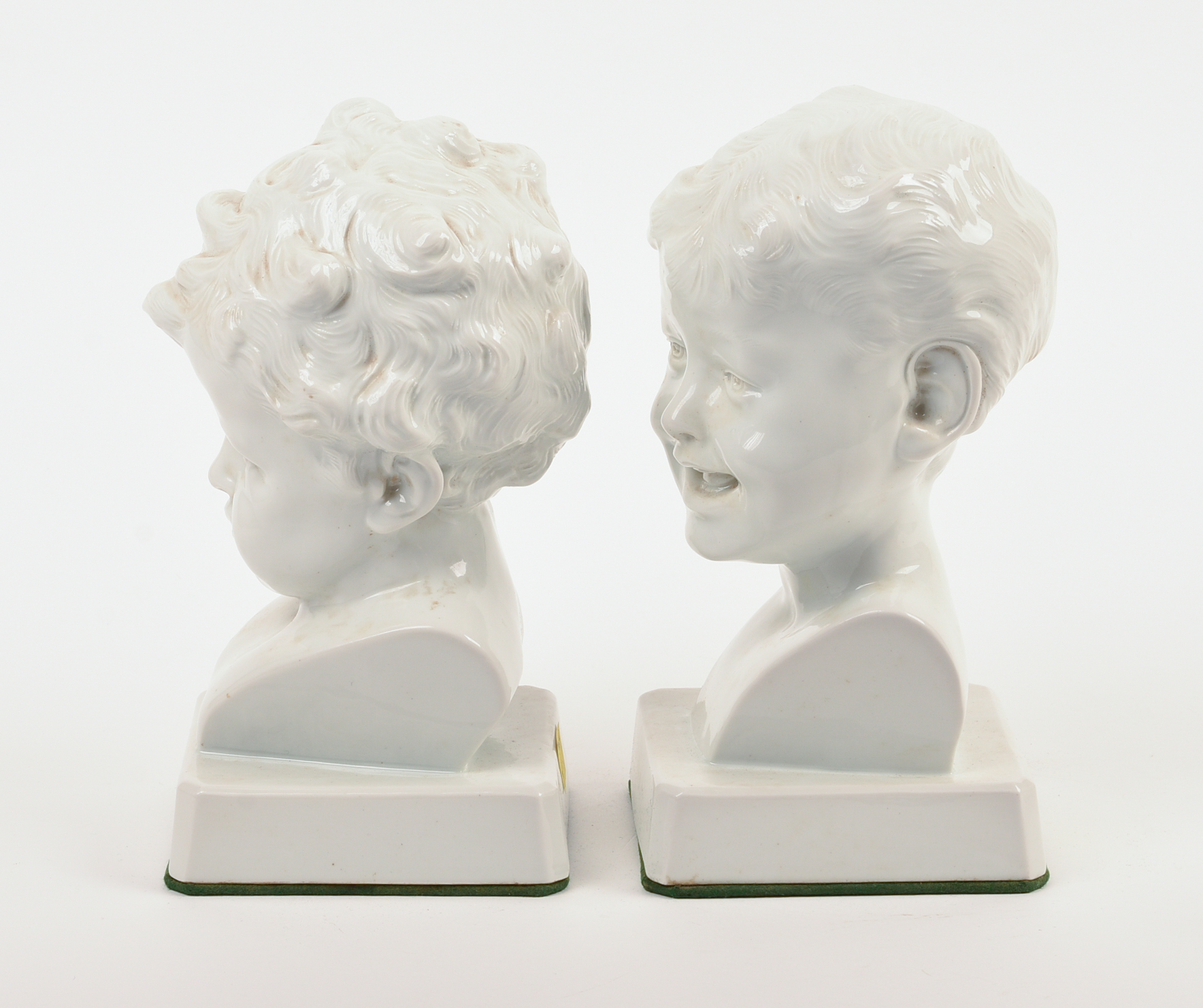 Pair of Signed Continental White Porcelain Busts of Boys