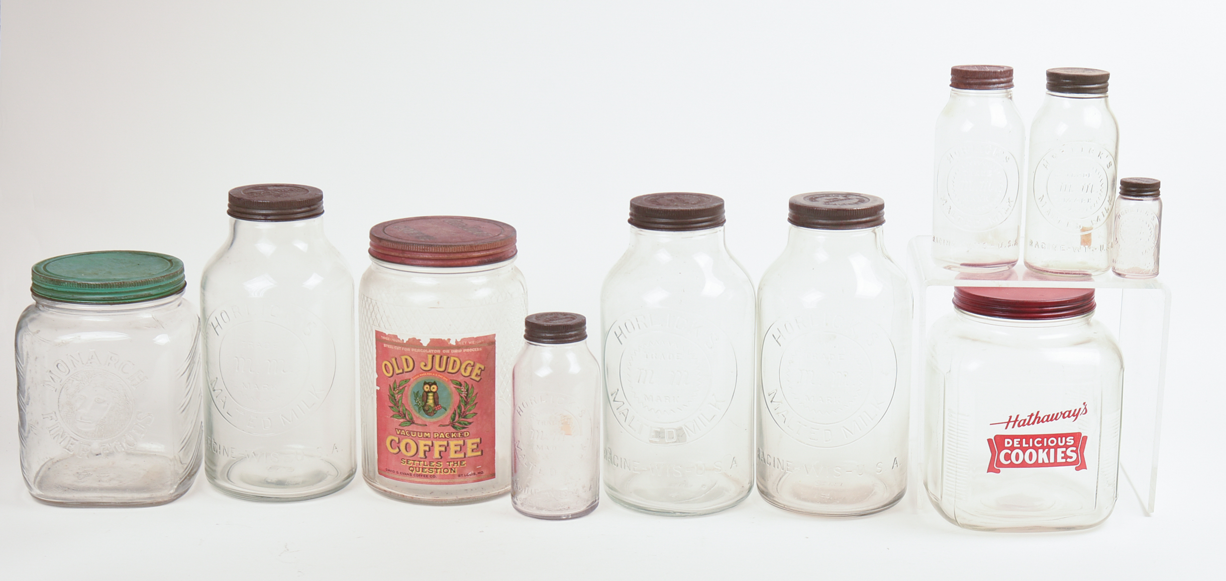Eight Glass Advertising Jars.