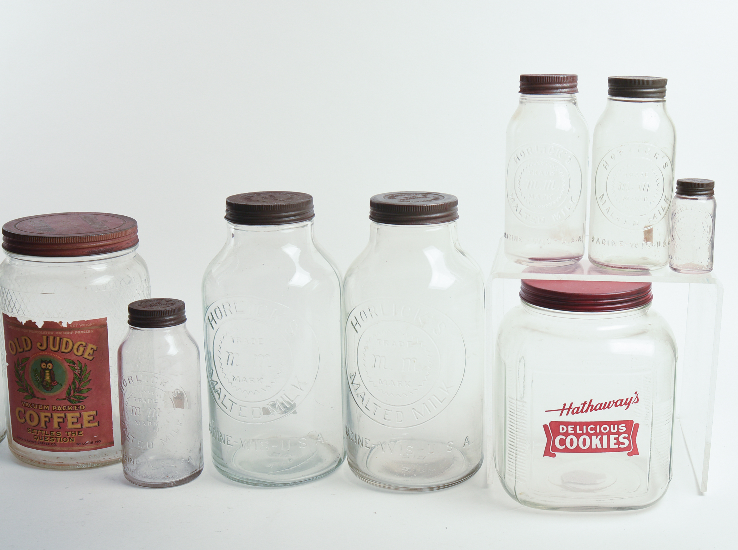 Eight Glass Advertising Jars.