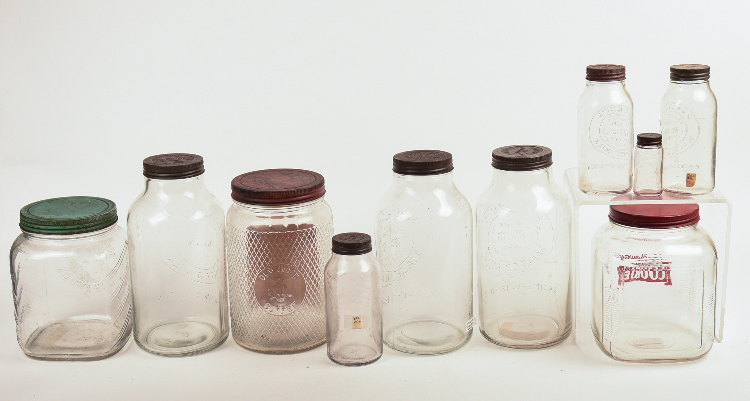 Eight Glass Advertising Jars.