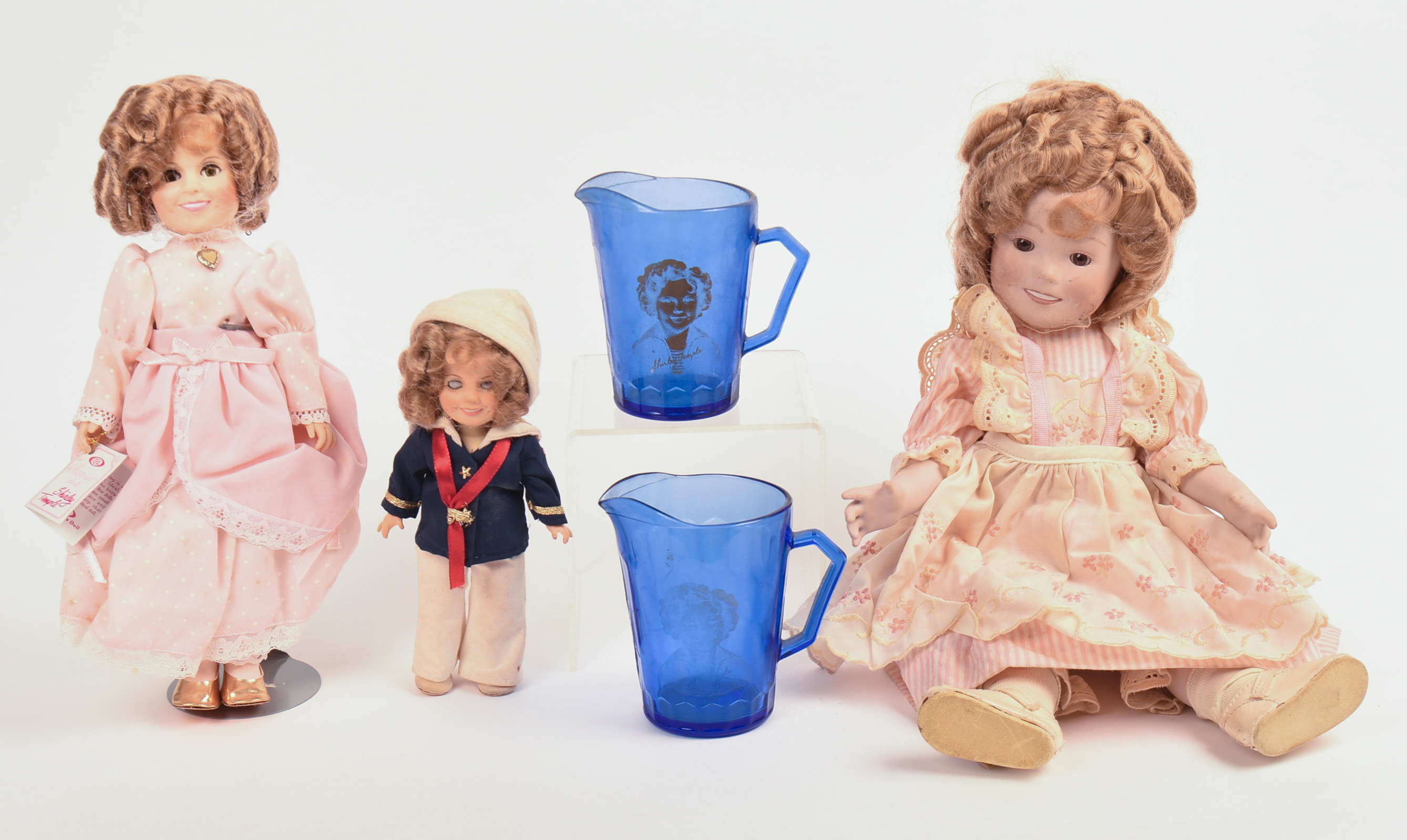 Three Ideal Shirley Temple Dolls and Two Glass Pitchers