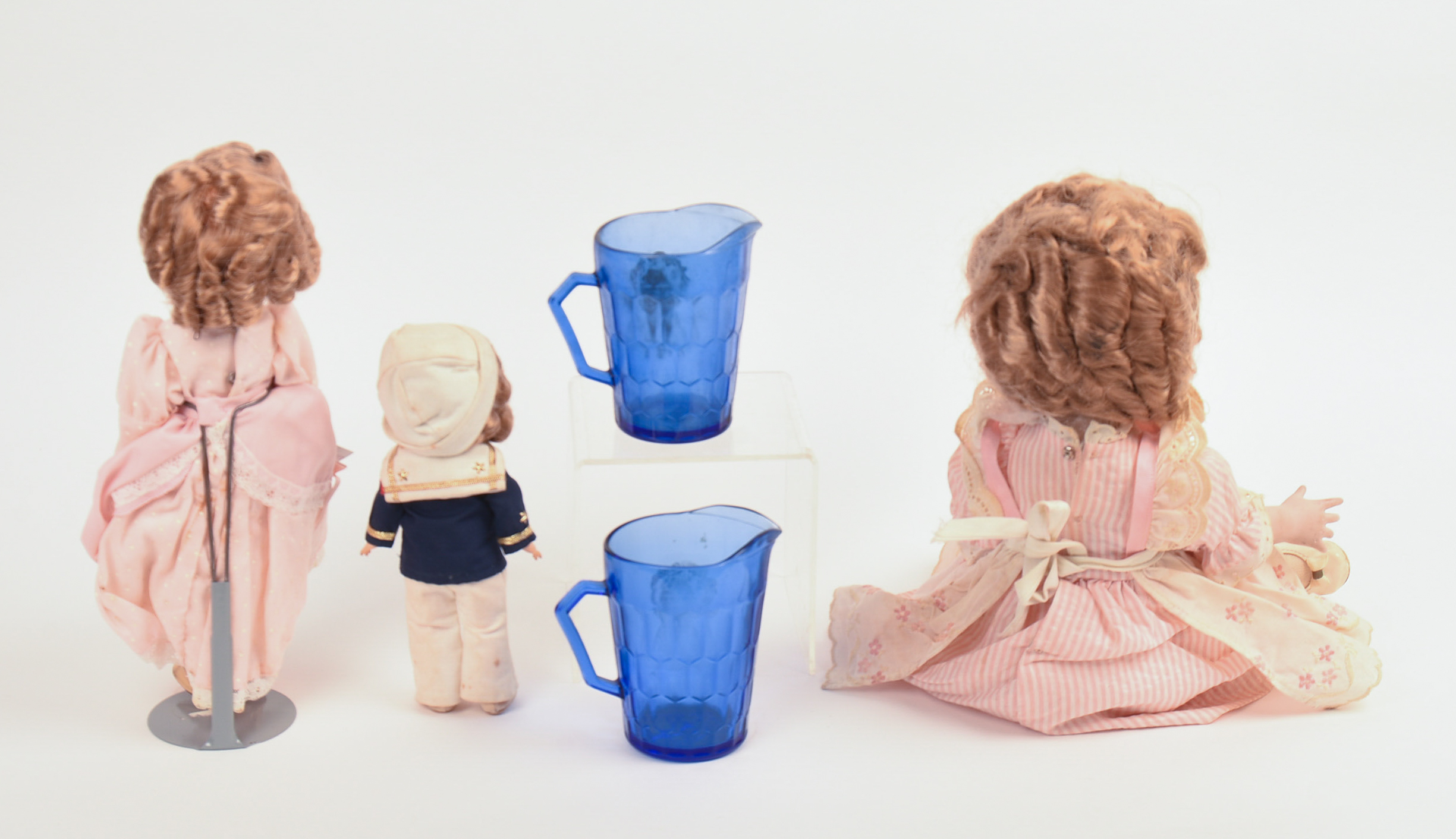 Three Ideal Shirley Temple Dolls and Two Glass Pitchers