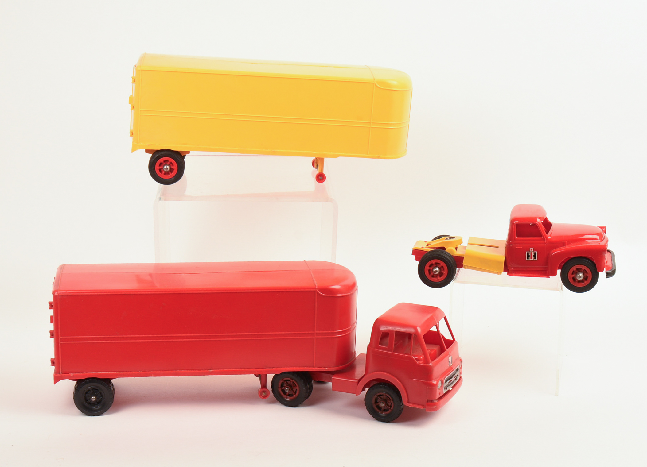 Two International Toy Trucks and a Trailer.