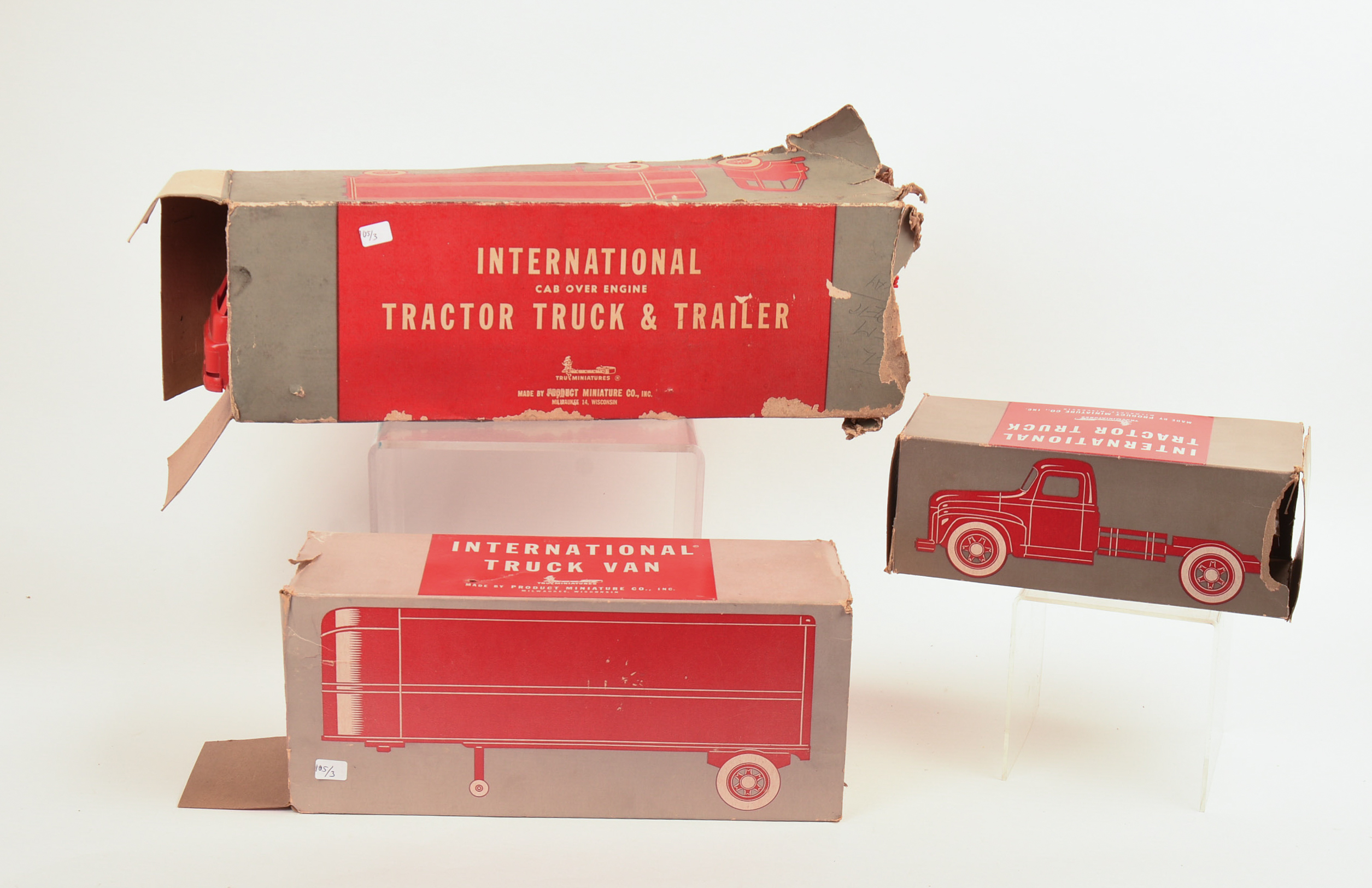 Two International Toy Trucks and a Trailer.