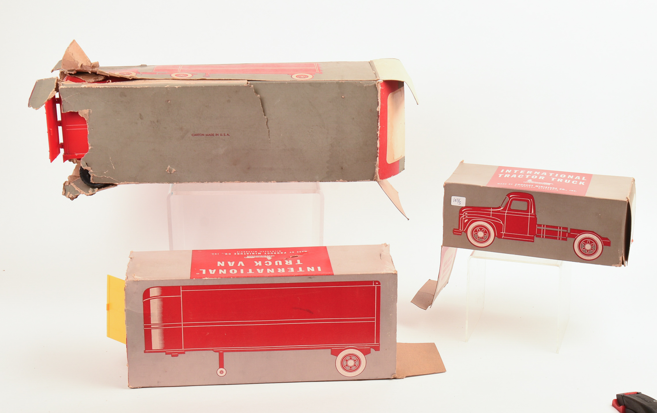 Two International Toy Trucks and a Trailer.