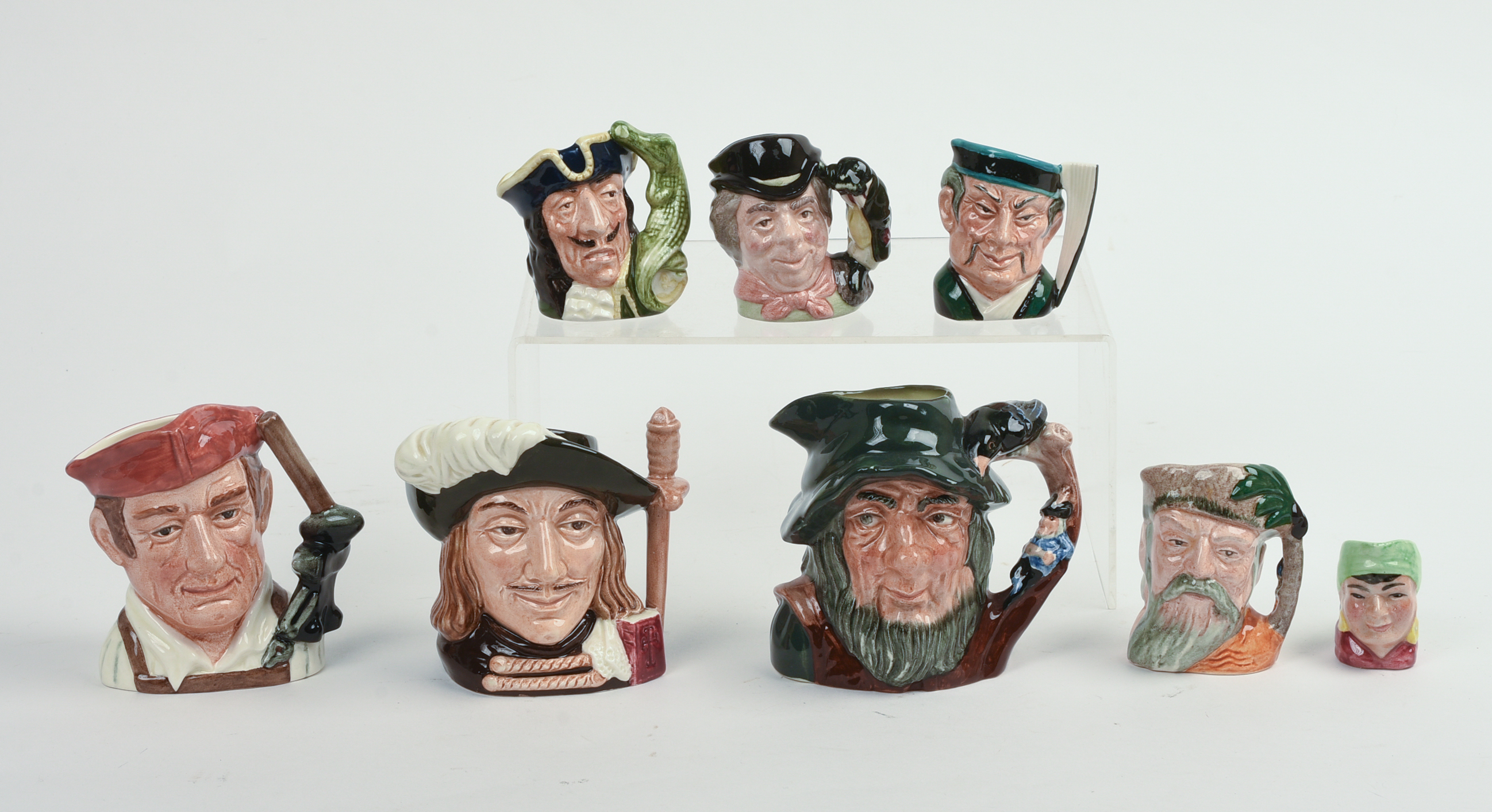 Eight Miniature Royal Doulton Character Pitchers.