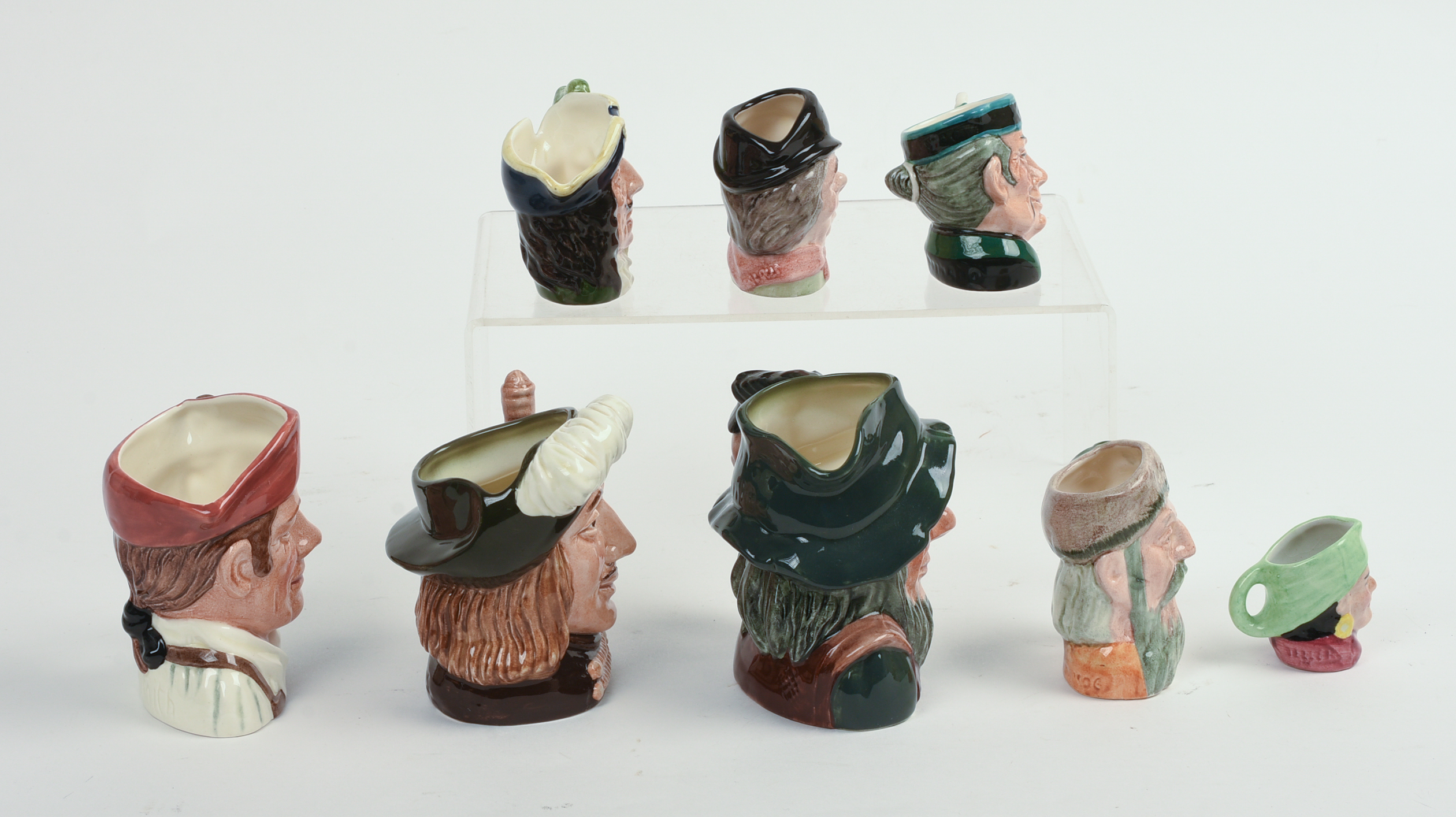 Eight Miniature Royal Doulton Character Pitchers.