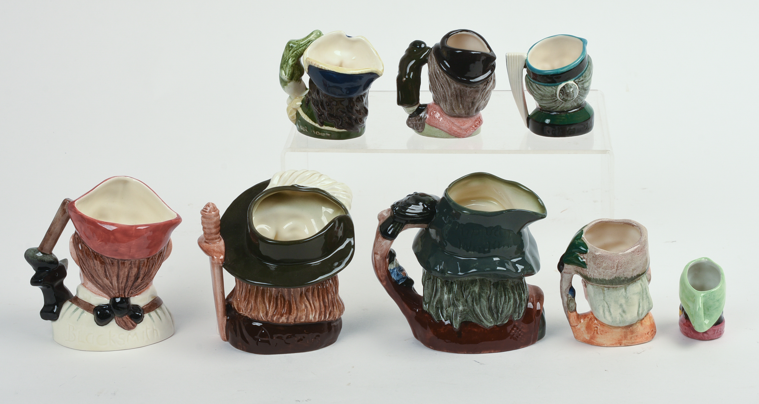 Eight Miniature Royal Doulton Character Pitchers.