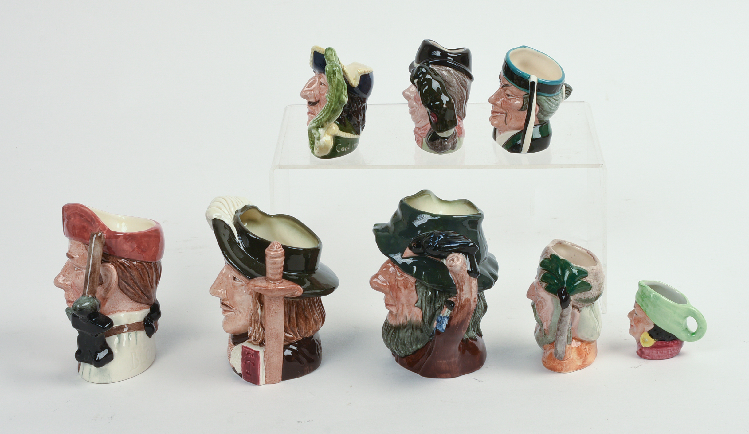 Eight Miniature Royal Doulton Character Pitchers.